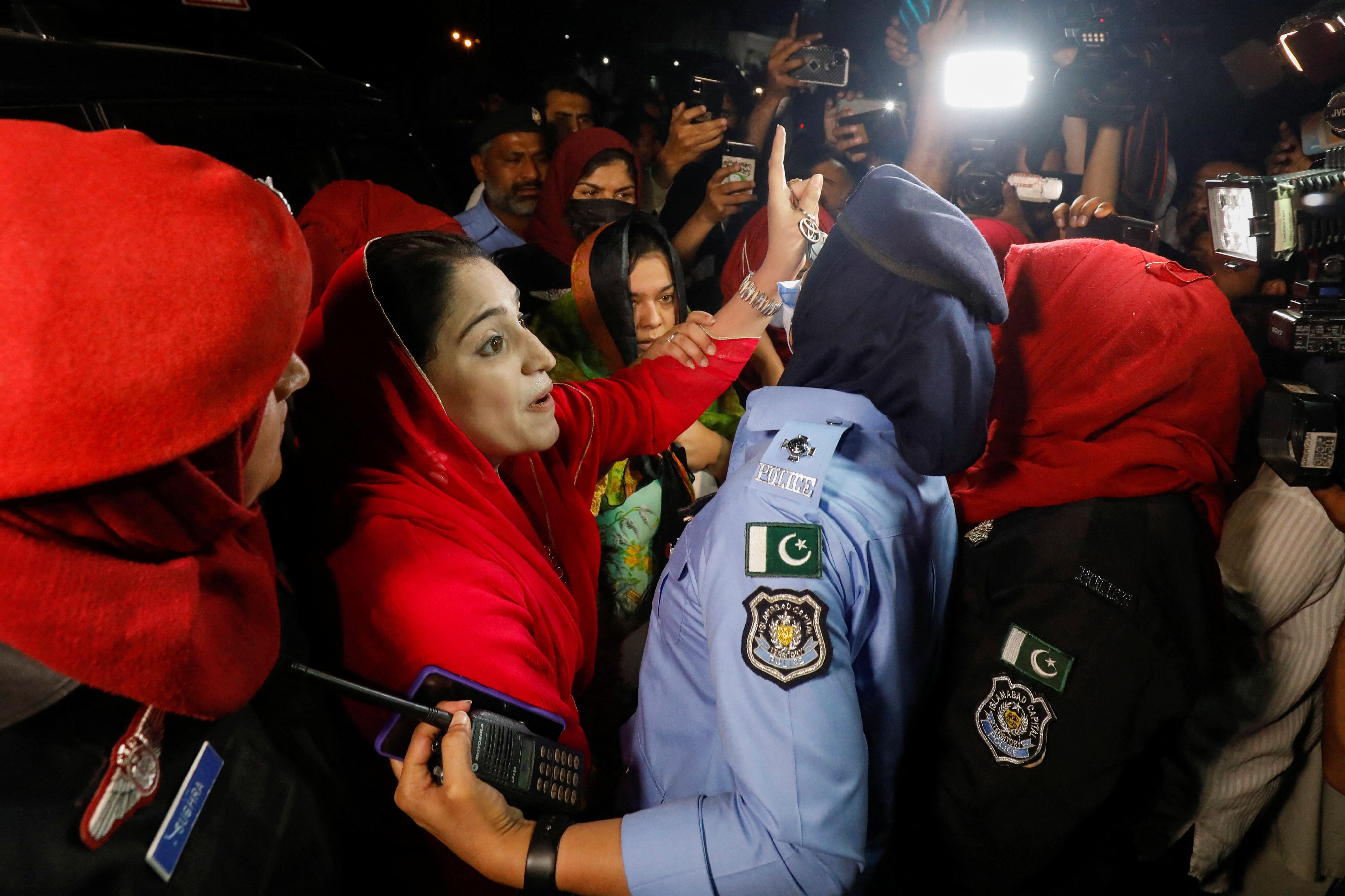 Police officers detain supporters of former Pakistani PM Khan during a protest in Islamabad