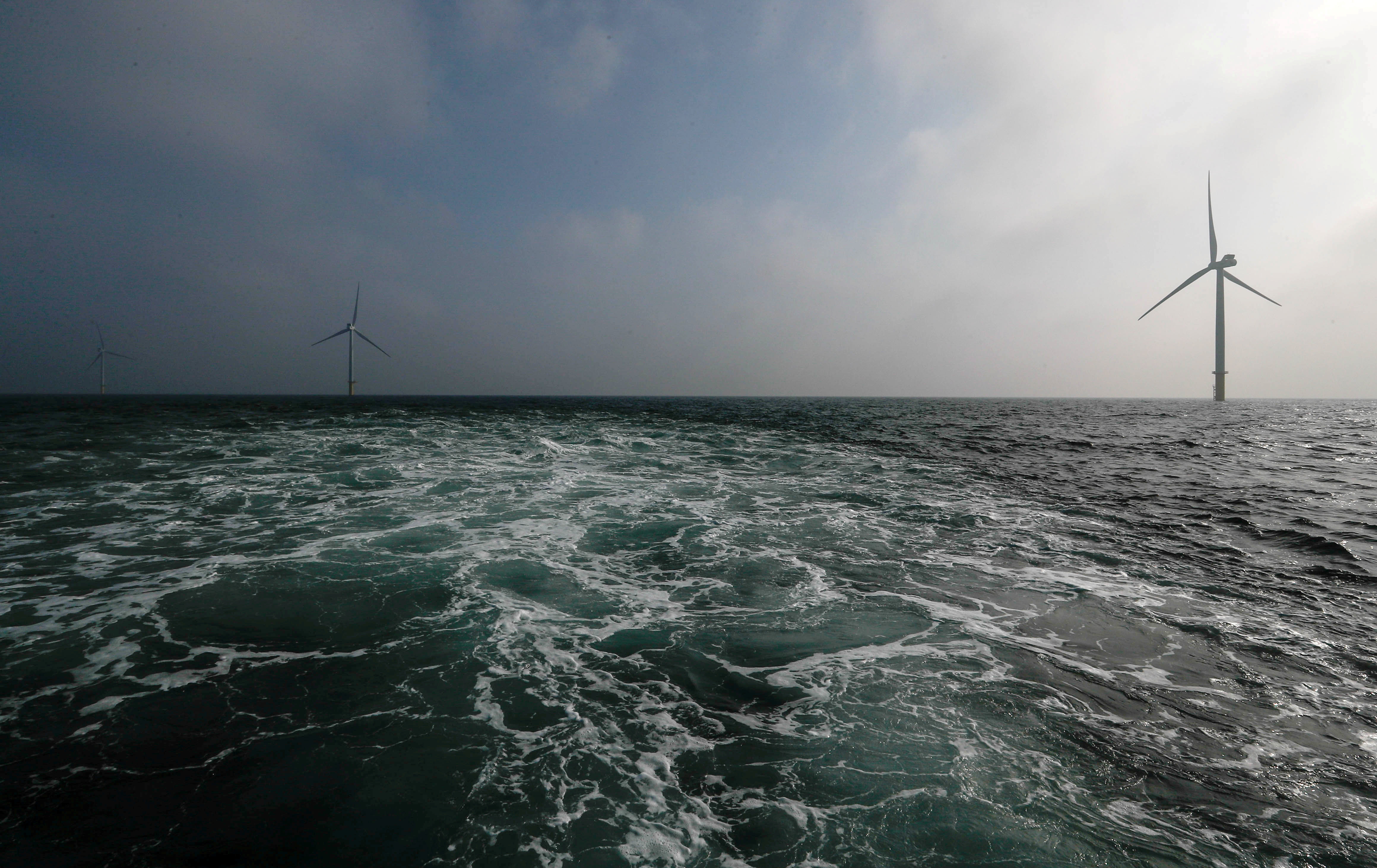 Power-generating windmill turbines are seen at the Eneco Luchterduinen offshore wind farm near Amsterdam