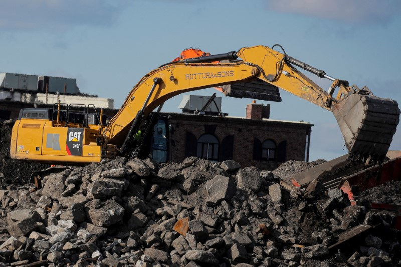 A Caterpillar (Cat) Excavator is seen working at a construction site near the New York Harbor in Brooklyn, New York