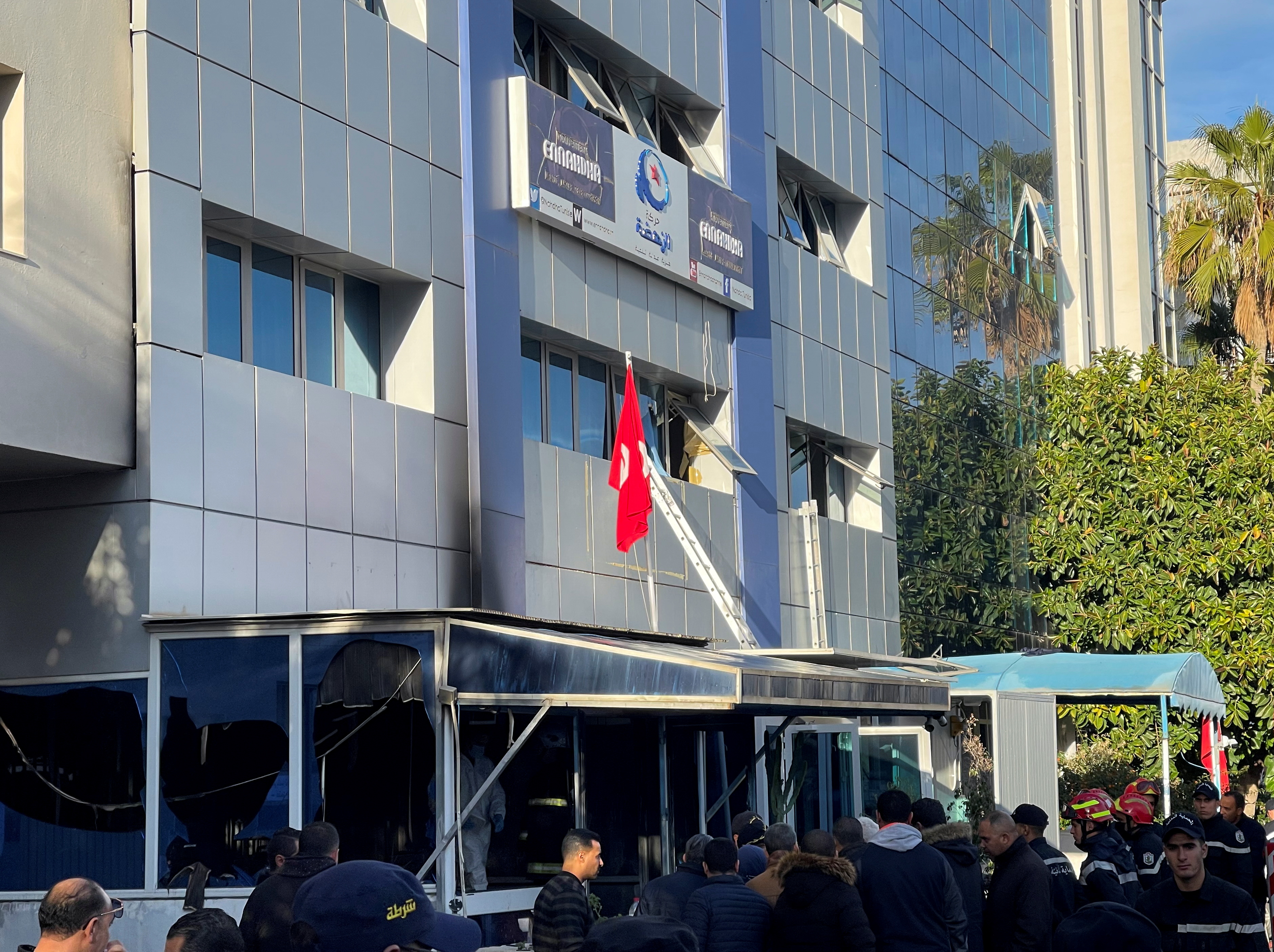 People stand outside the headquarters of Tunisia's Ennahda party after a fire broke out a the building in Tunis, Tunisia December 9, 2021. REUTERS/Jihed Abidellaoui