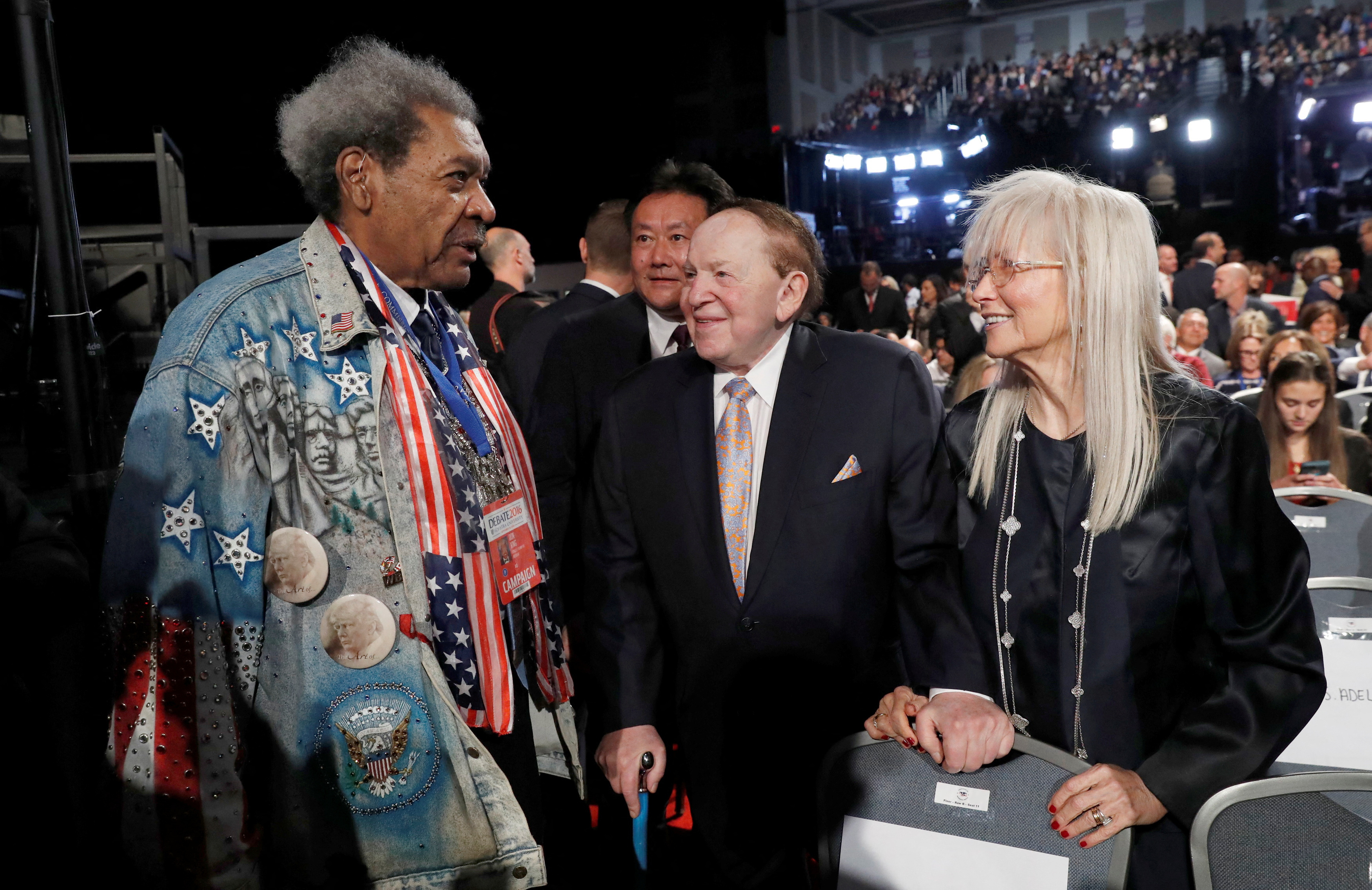 Boxing promoter Don King talks with fellow Donald Trump supporters Casino owner Sheldon Adelson and his wife Miriam before the start of the first U.S. presidential debate at Hofstra University in Hempstead