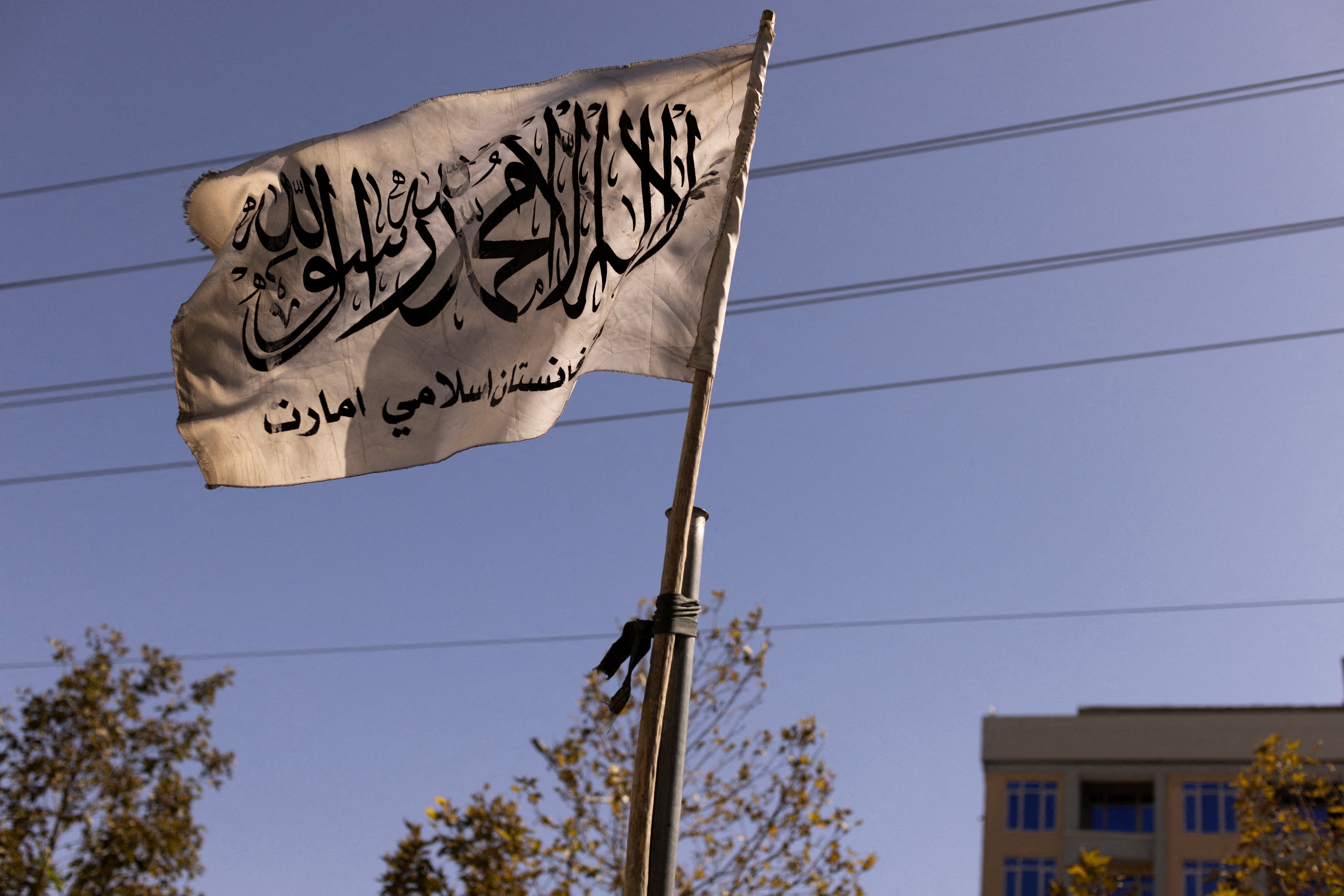 An Islamic Emirate of Afghanistan flag hangs over a street in Kabul, Afghanistan, October 19, 2021. Picture taken October 19, 2021. REUTERS/Jorge Silva