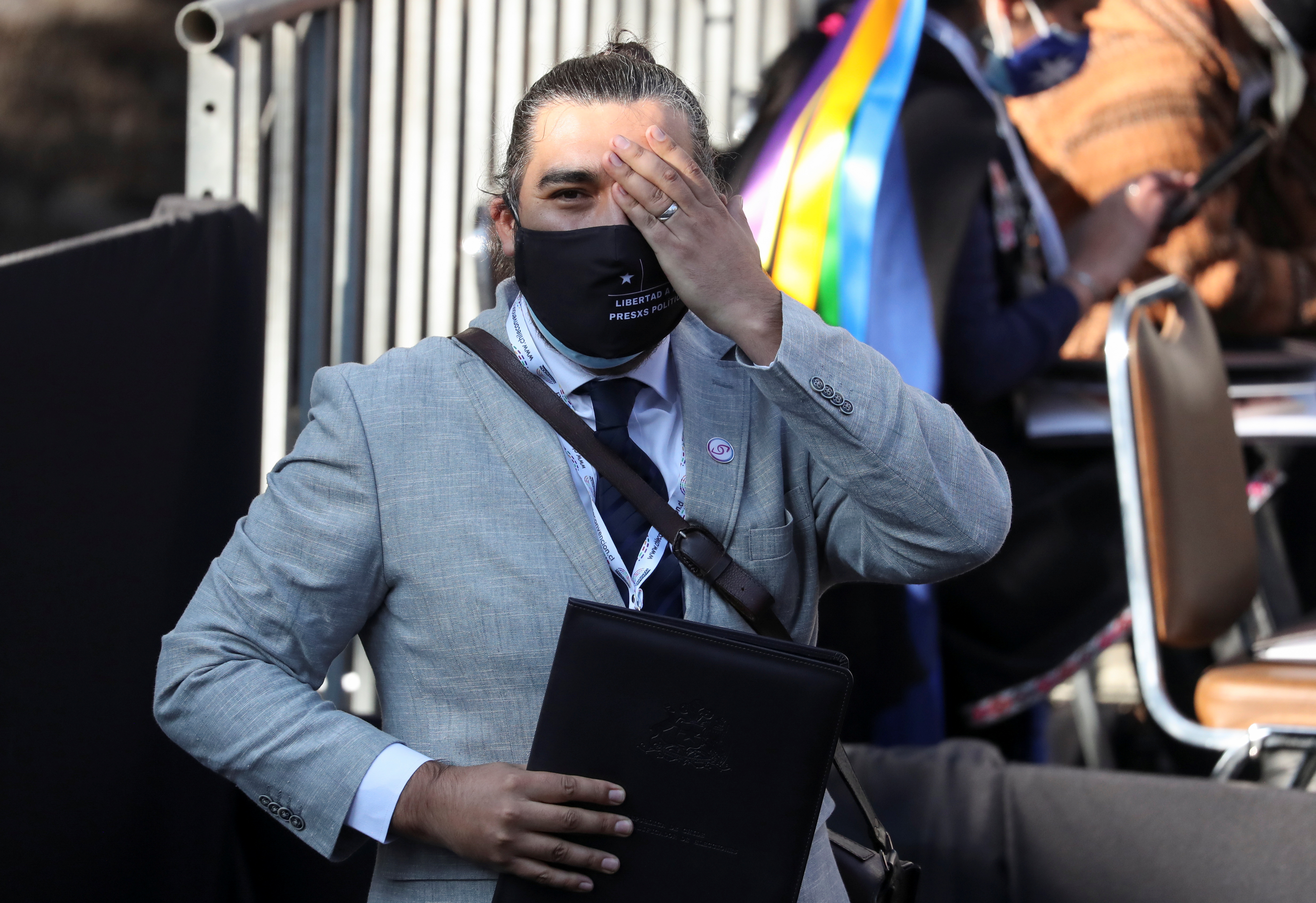 A constitutional assembly member covers his eye in support of people who lost their eyes during protests, as they gather for the first session to draft a new constitution, in Santiago, Chile July 4, 2021. REUTERS/Ivan Alvarado