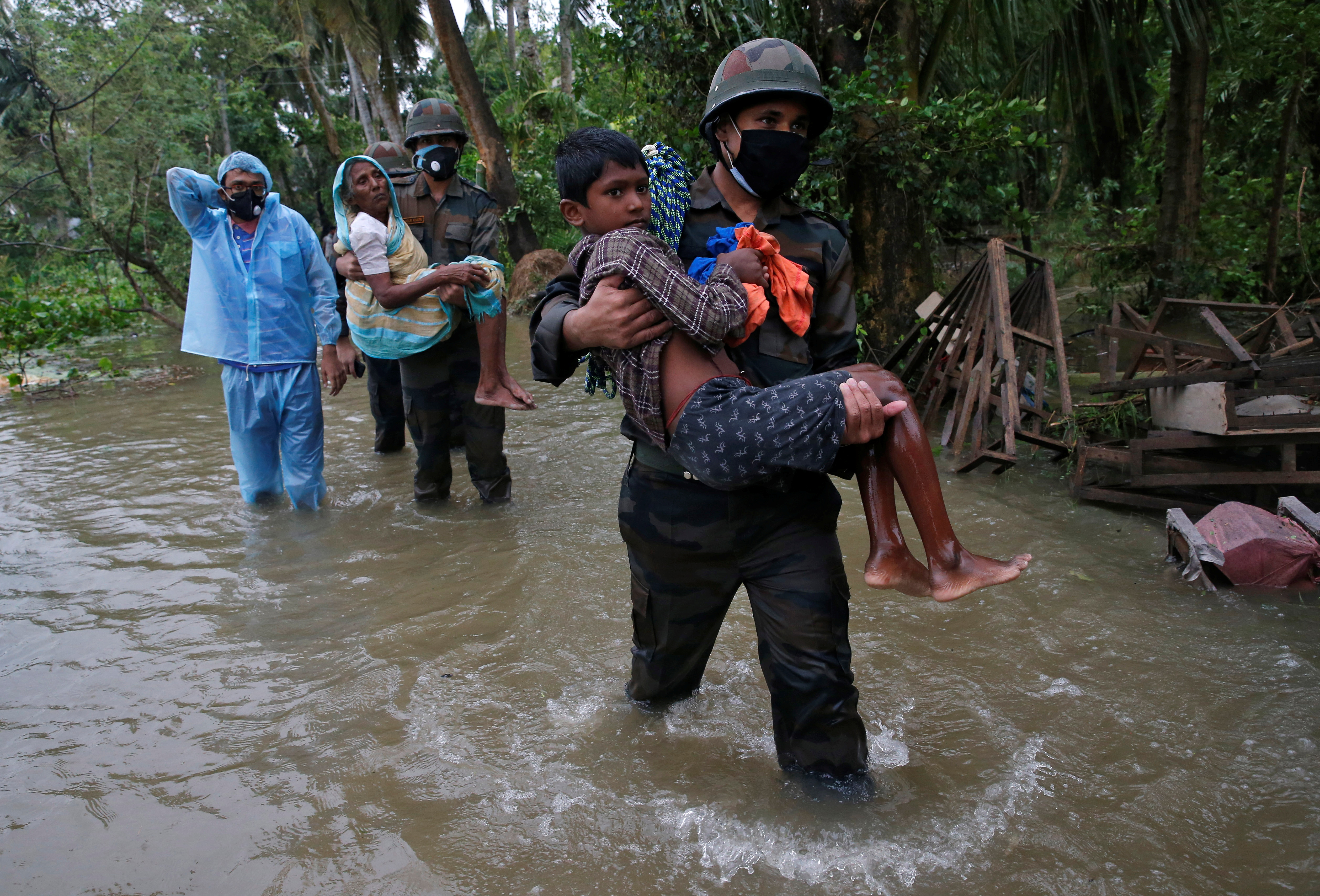 Army soldiers evacuate people from a flooded area to safer places as Cyclone Yaas makes landfall at Ramnagar