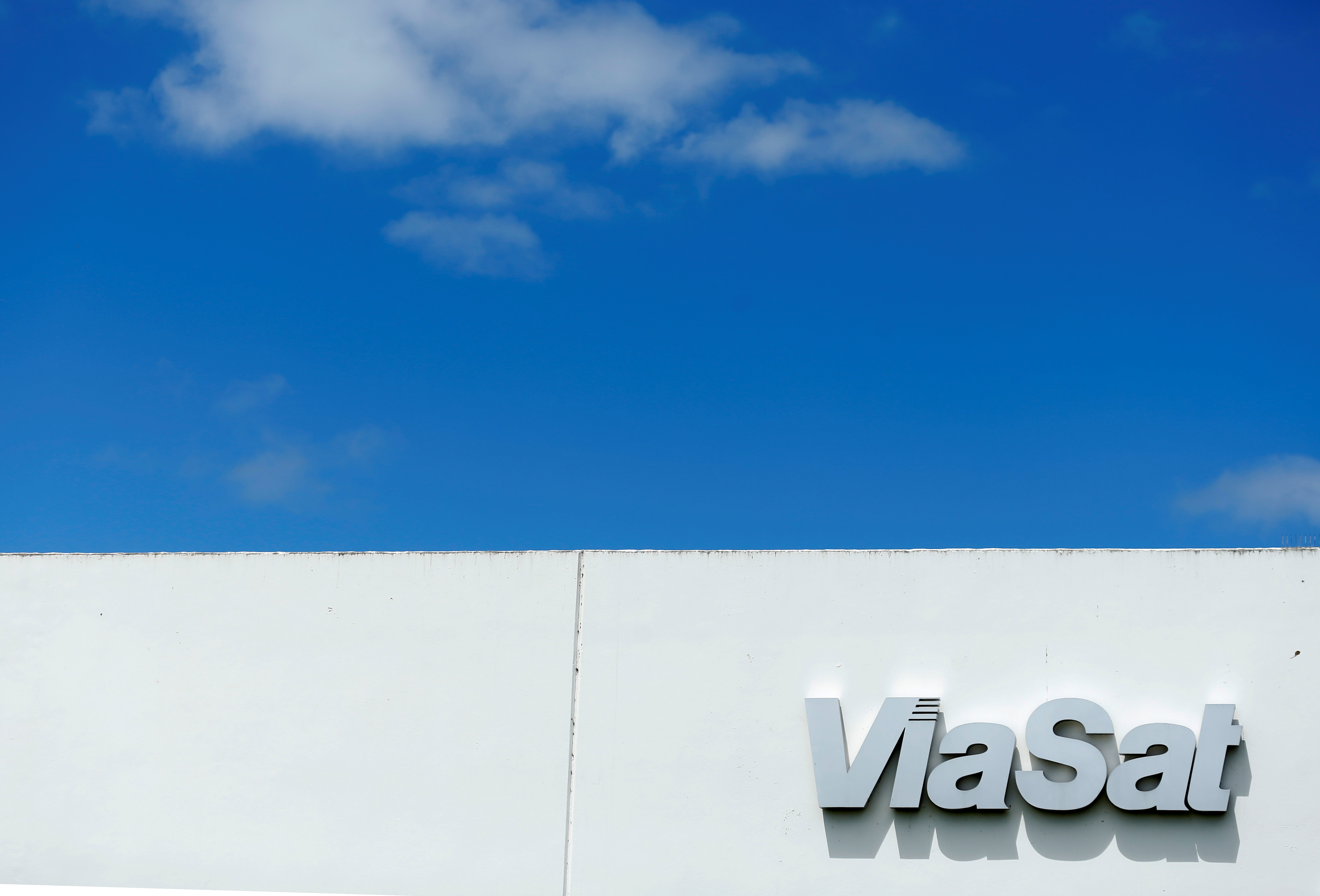 A Viasat inc. sign is shown on one of their buildings in Carlsbad, California