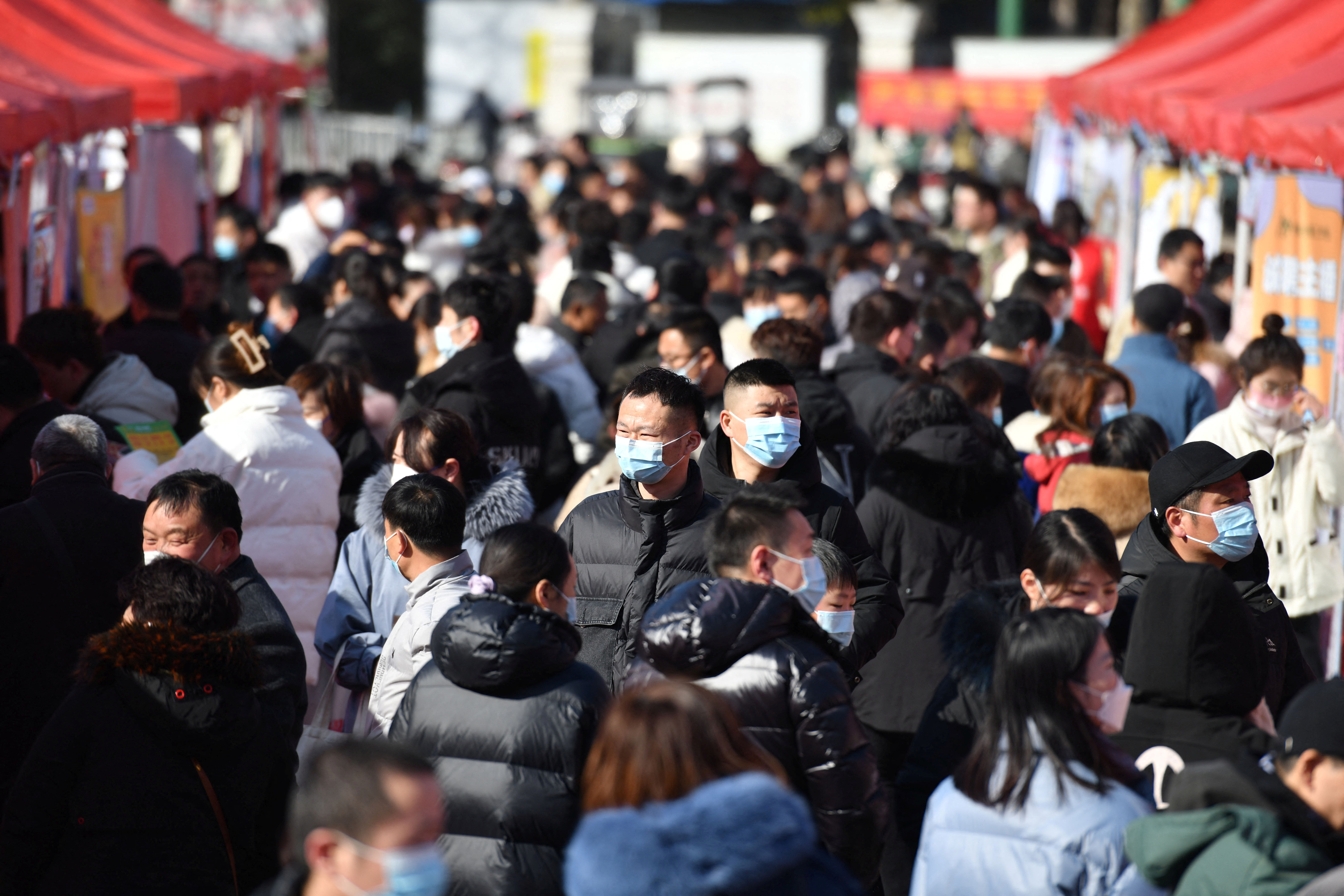People attend a job fair in Fuyang