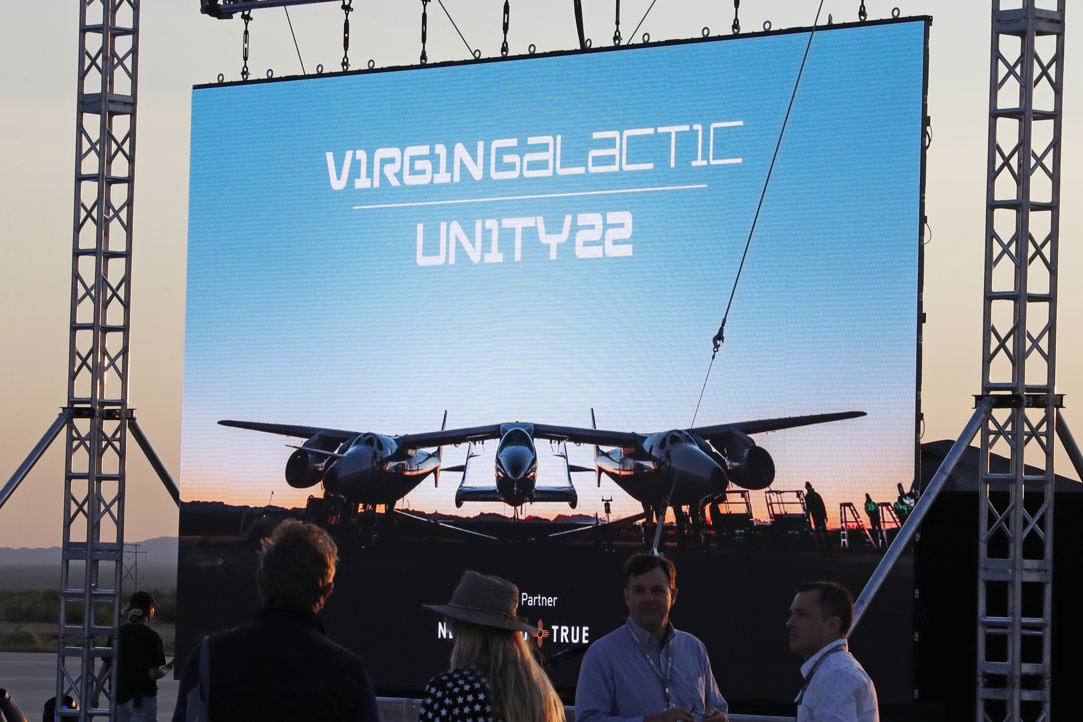 Guests assemble before billionaire entrepreneur Richard Branson departs with his crew for travel to the edge of space in Virgin Galactic's passenger rocket plane VSS Unity, near Truth or Consequences, New Mexico, U.S., July 11, 2021. REUTERS/Joe Skipper