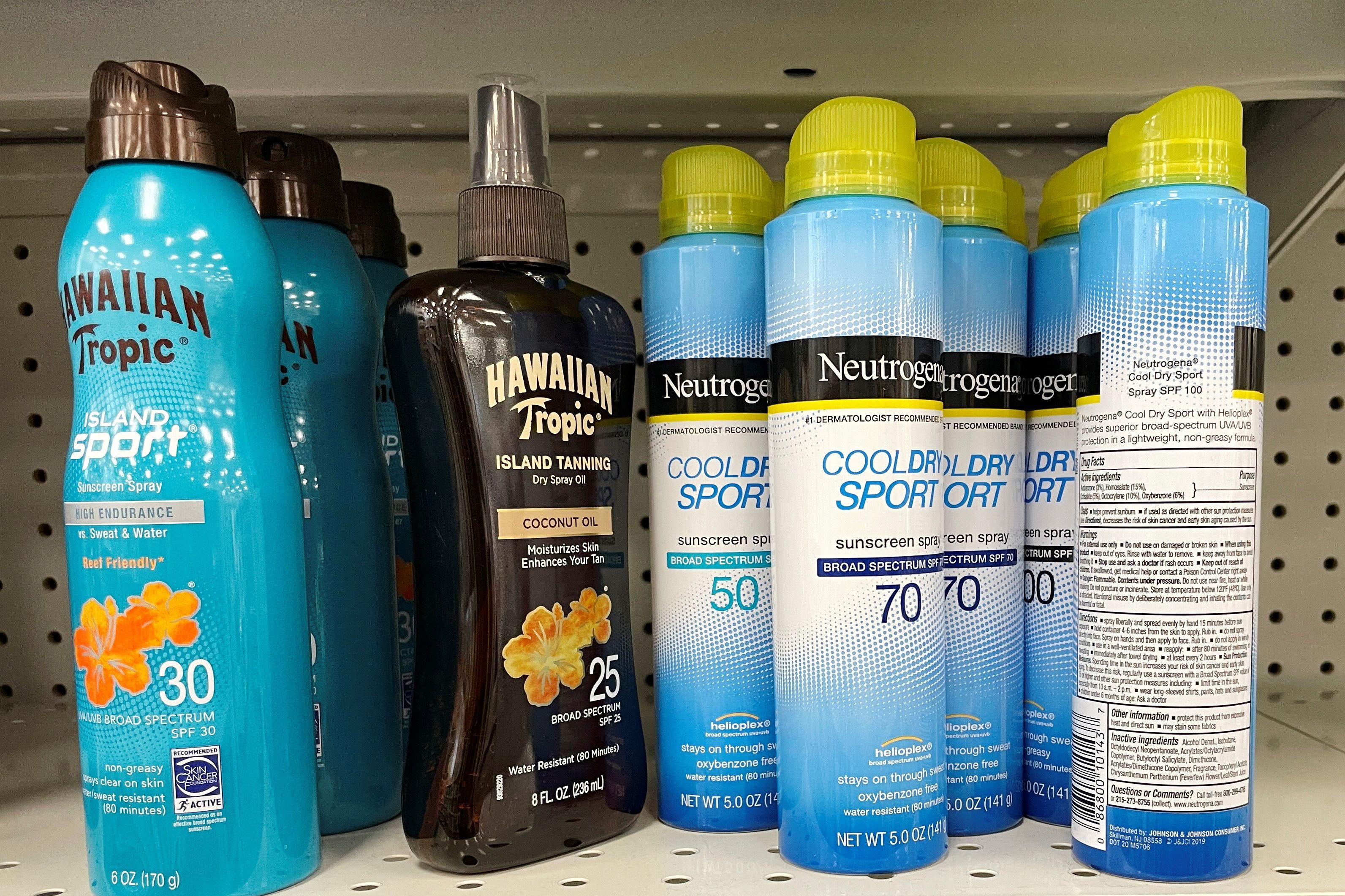 Sunscreens being recalled by Johnson & Johnson sit on a store shelf in Gloucester