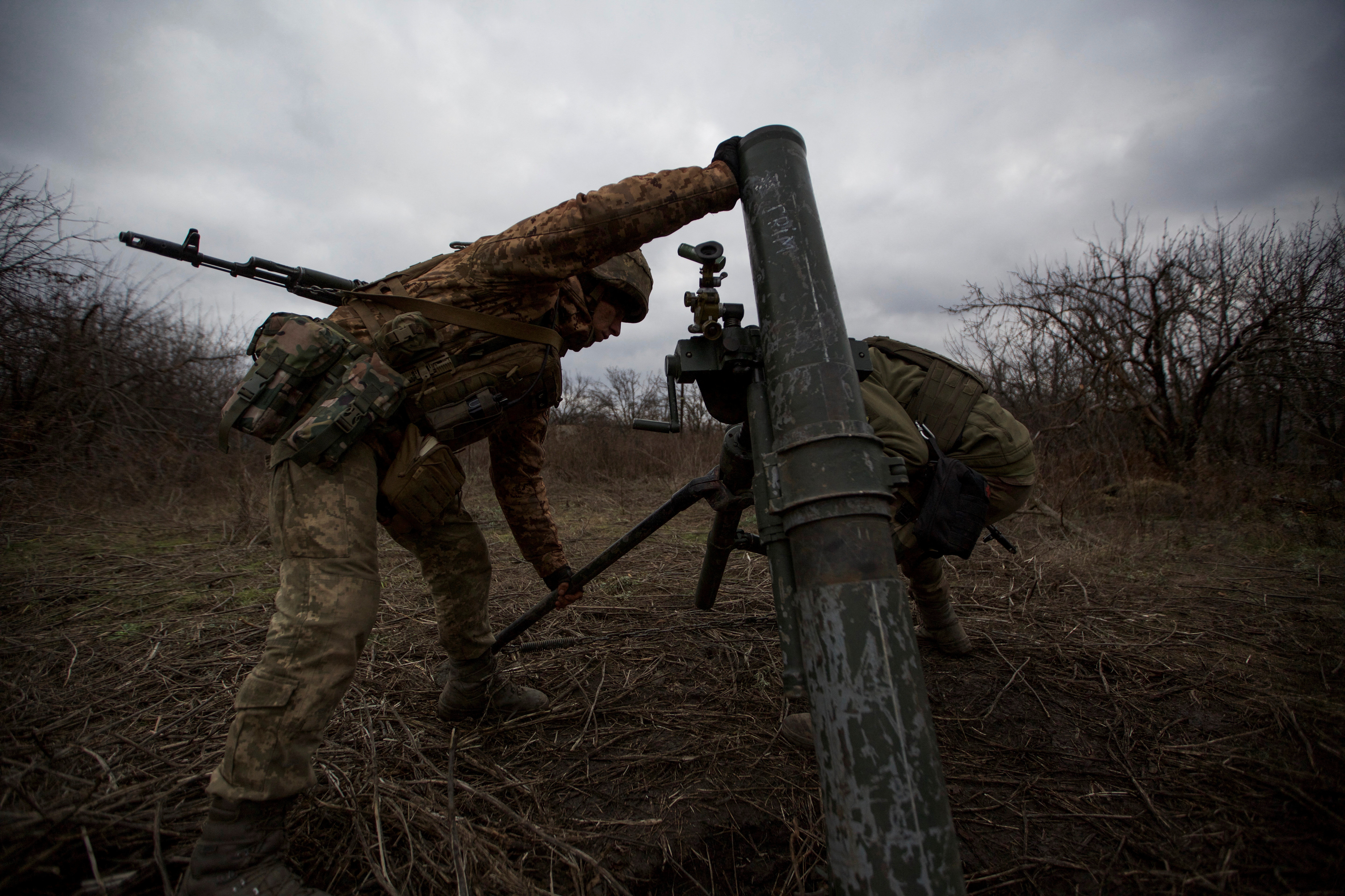 Ukrainian servicemen set up a mortar for firing it towards positions of Russian troops, in the outskirts of Bakhmut