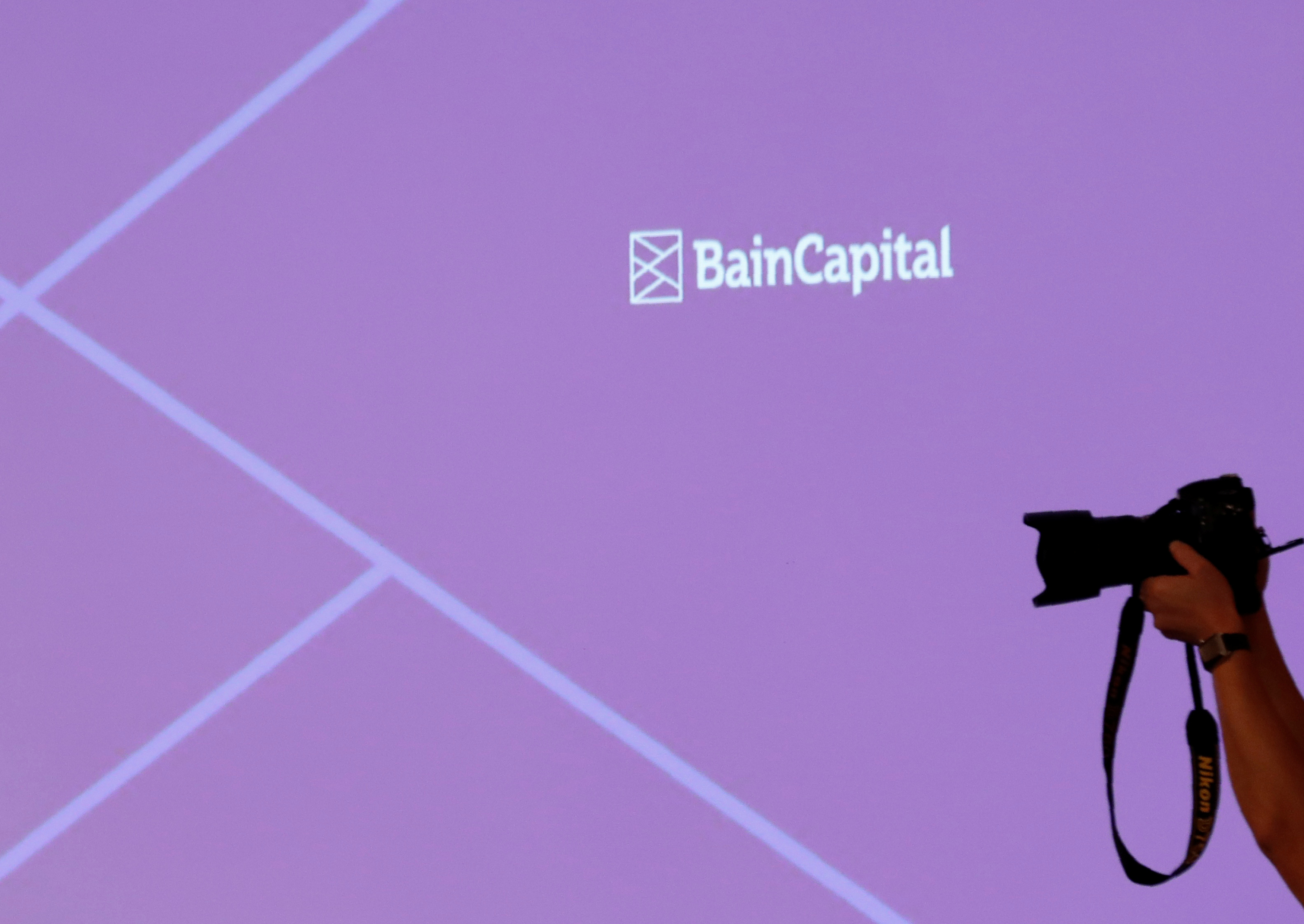 The logo of Bain Capital is displayed on the screen during a news conference in Tokyo