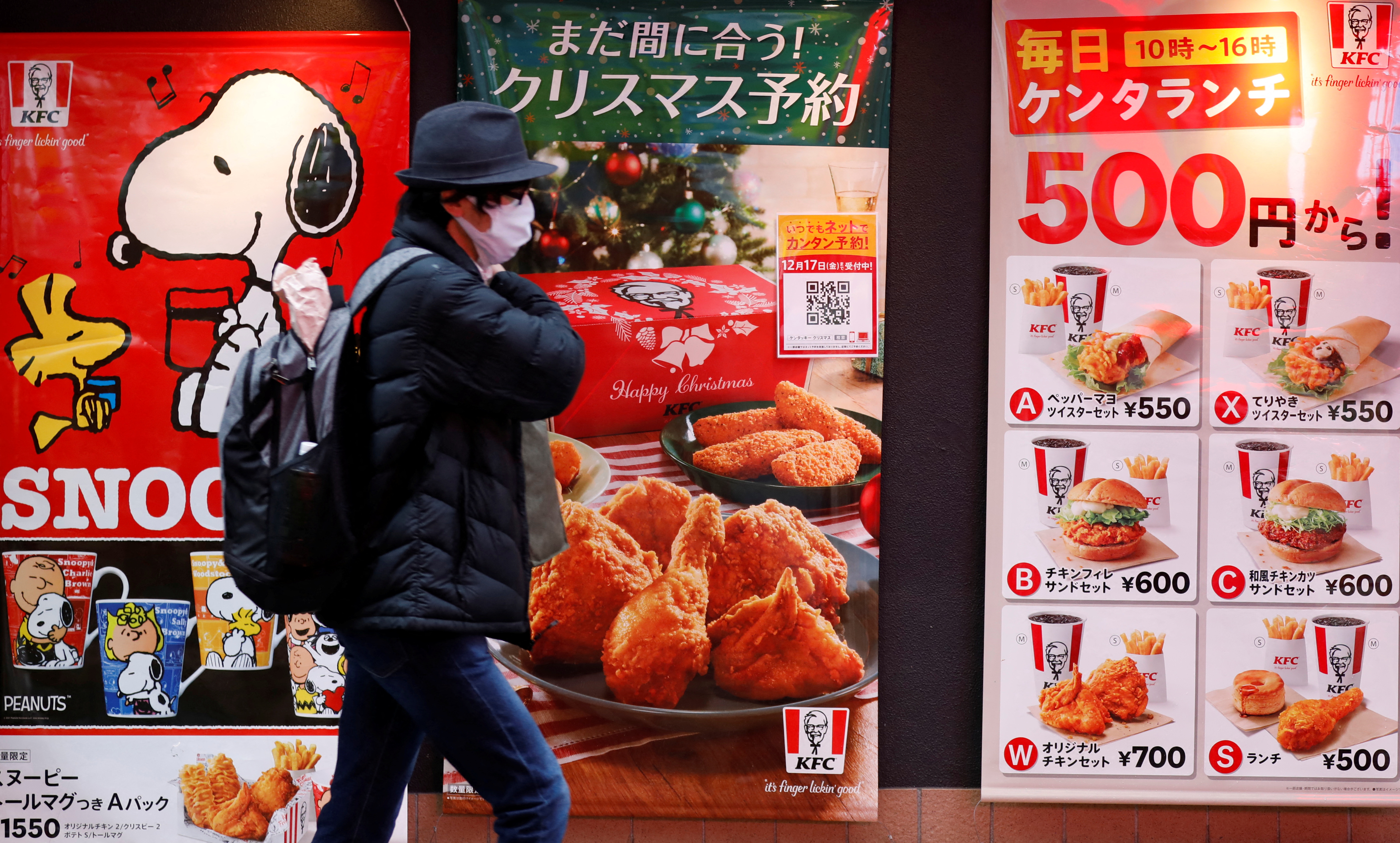 A man wearing a protective mask, amid the coronavirus disease outbreak, walks past a Kentucky Fried Chicken (KFC) restaurant in Tokyo