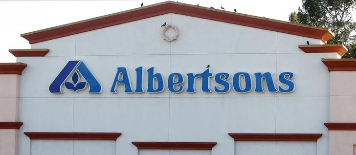 Birds perch upon signage for an Albertsons grocery store in Burbank, California
