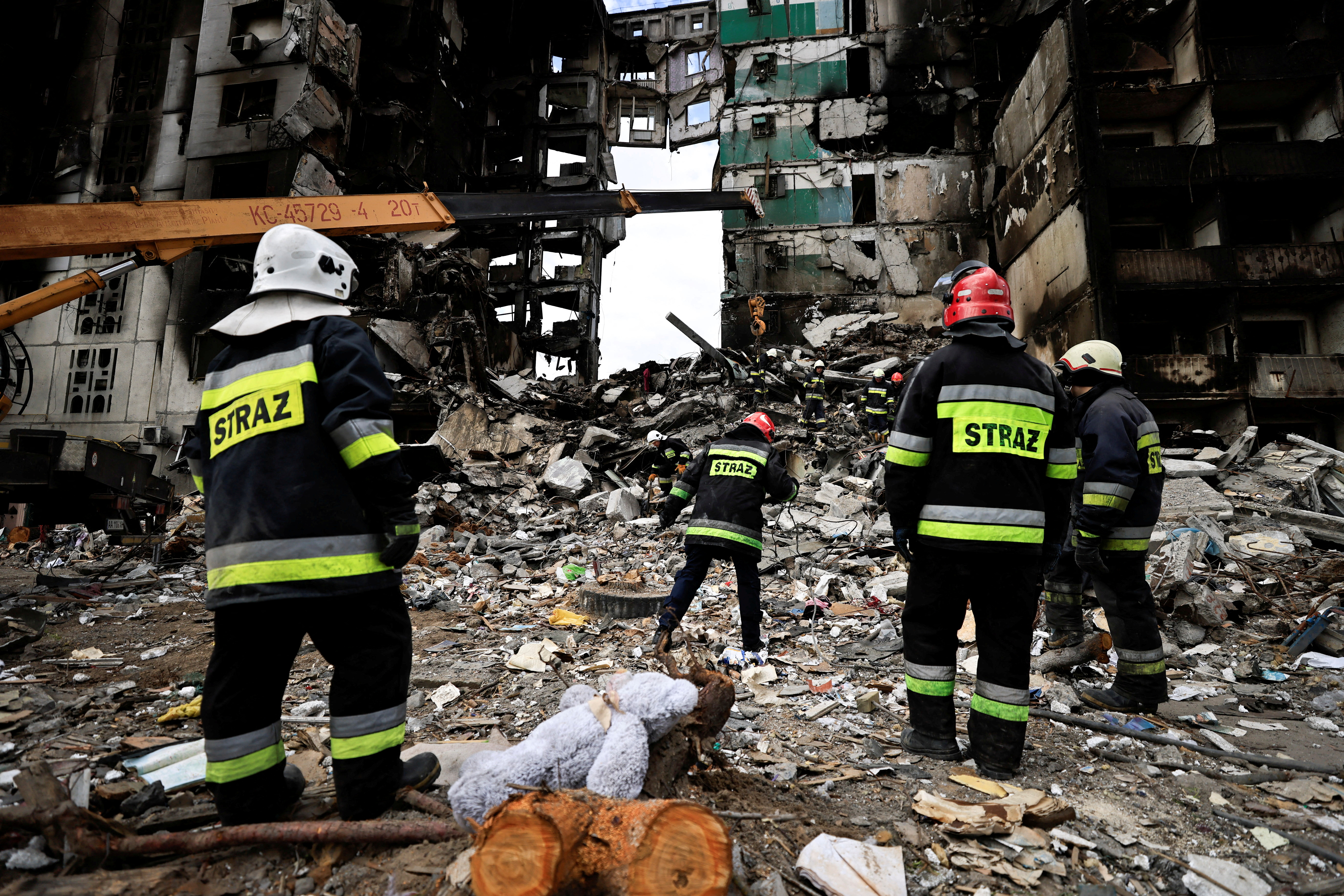 Rescuers search for bodies under the rubble of a building destroyed by Russian shelling, amid Russia's invasion of Ukraine, in Borodyanka