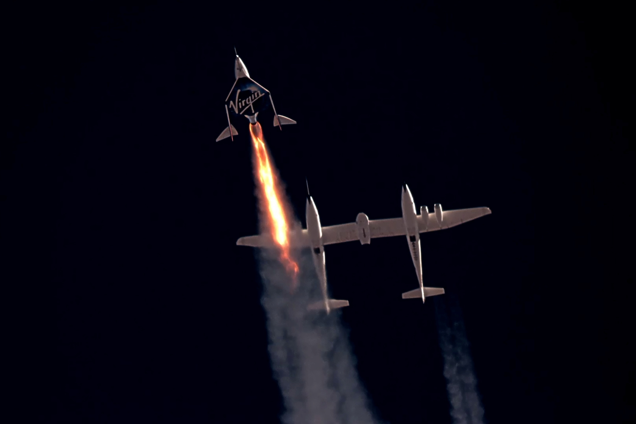 Virgin Galactic's passenger rocket plane VSS Unity, carrying Richard Branson and crew, begins its ascent to the edge of space above Spaceport America near Truth or Consequences, New Mexico, U.S. July 11, 2021 in a still image from video.    Virgin Galactic/Handout via REUTERS. 