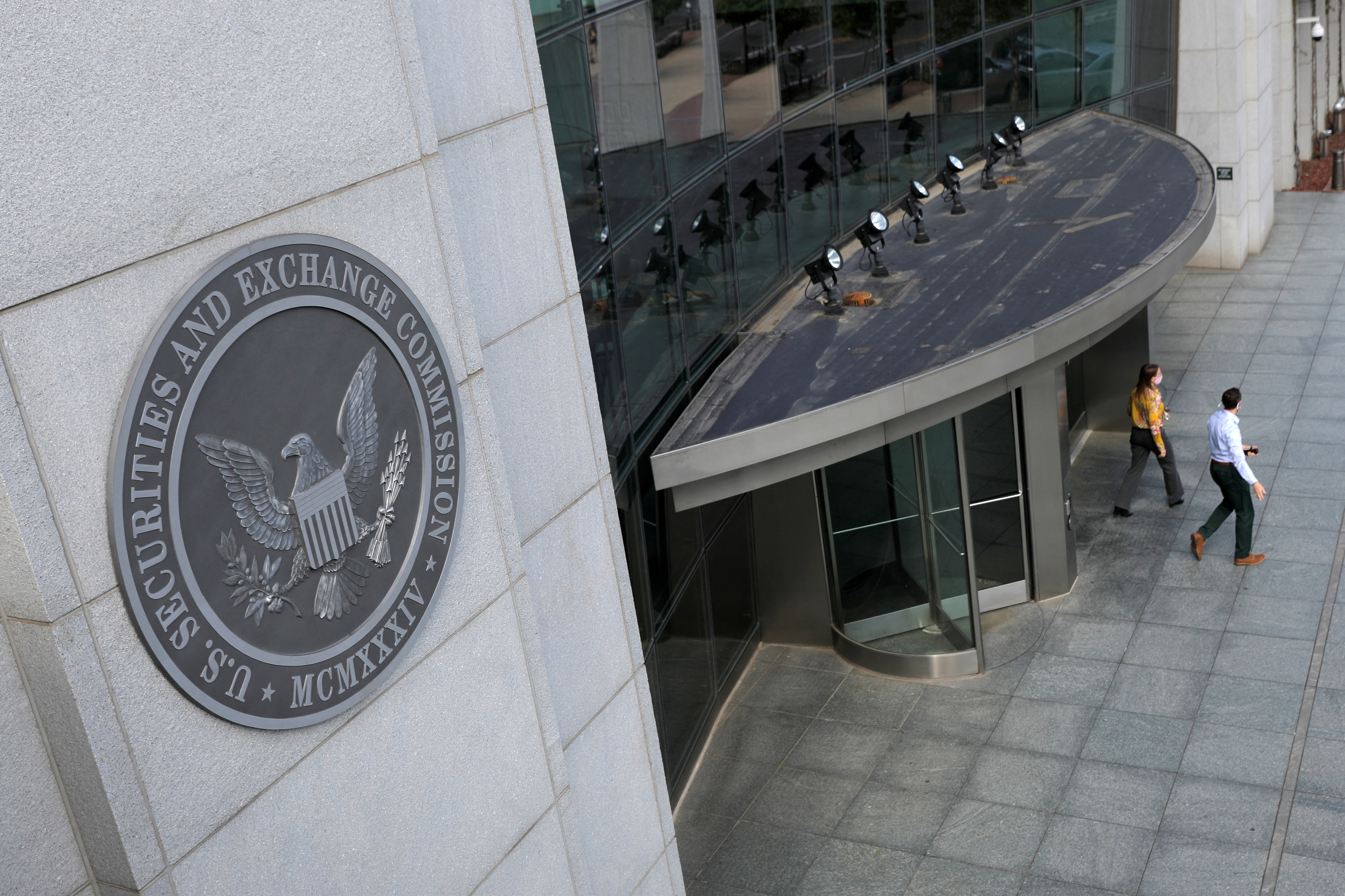 FILE PHOTO: People exit the headquarters of the U.S. Securities and Exchange Commission (SEC) in Washington, D.C.