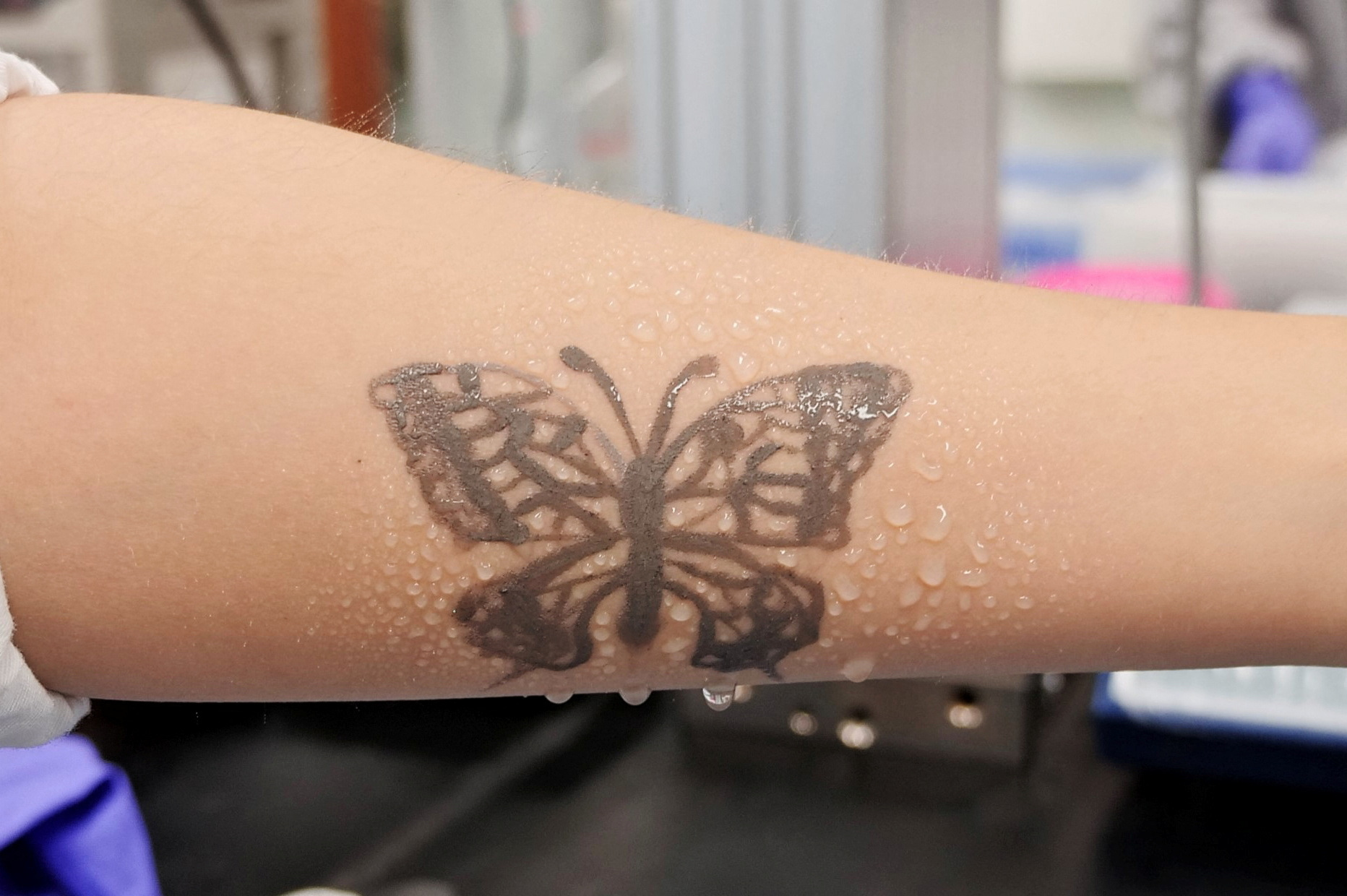 Water sprays on arm are seen with an electronic tattoo (e-tattoo) for the wettability test at the Korea Advanced Institute of Science and Technology (KAIST) in Daejeon