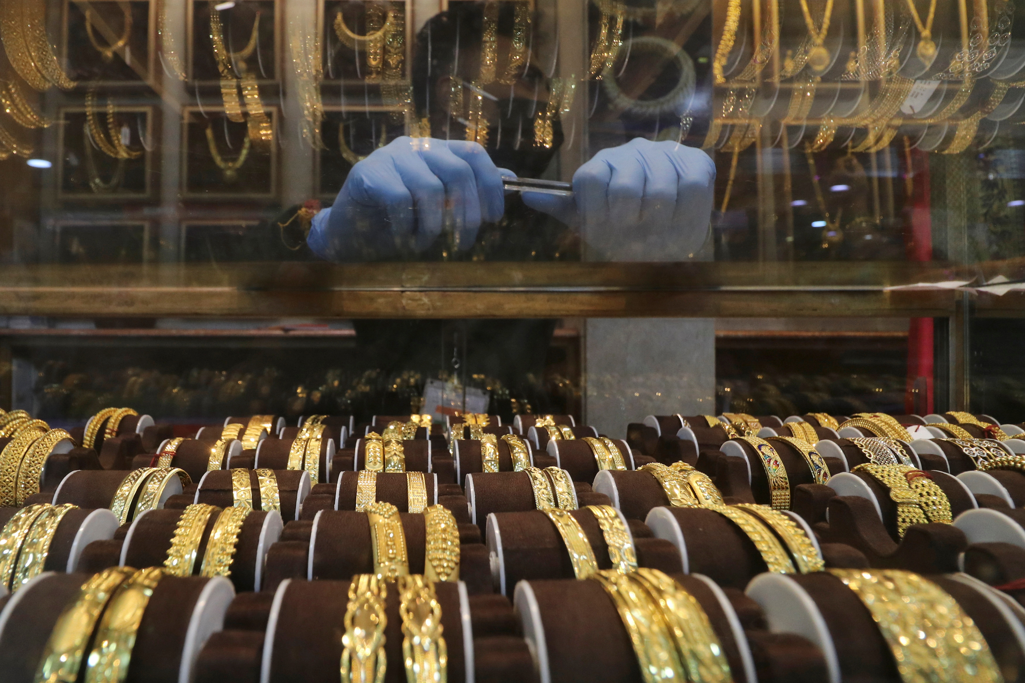 Seller waits for customers at a jewellery showroom during Dhanteras, a Hindu festival associated with Lakshmi, the goddess of wealth, amidst the spread of COVID-19 in Mumbai