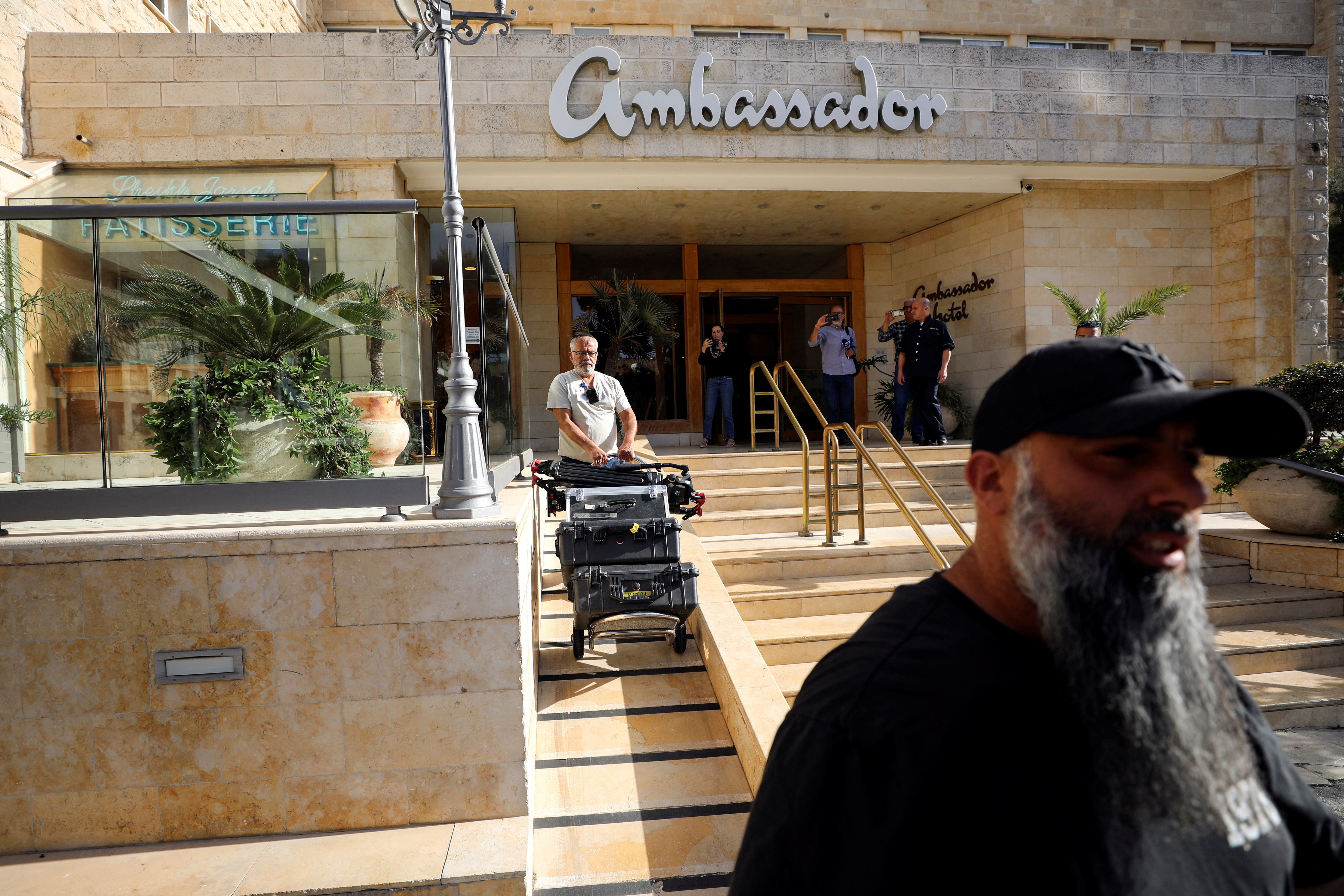 A man maneuvers media equipment following an Israeli police raid on an Al Jazeera de facto office at the Ambassador Hotel in Jerusalem