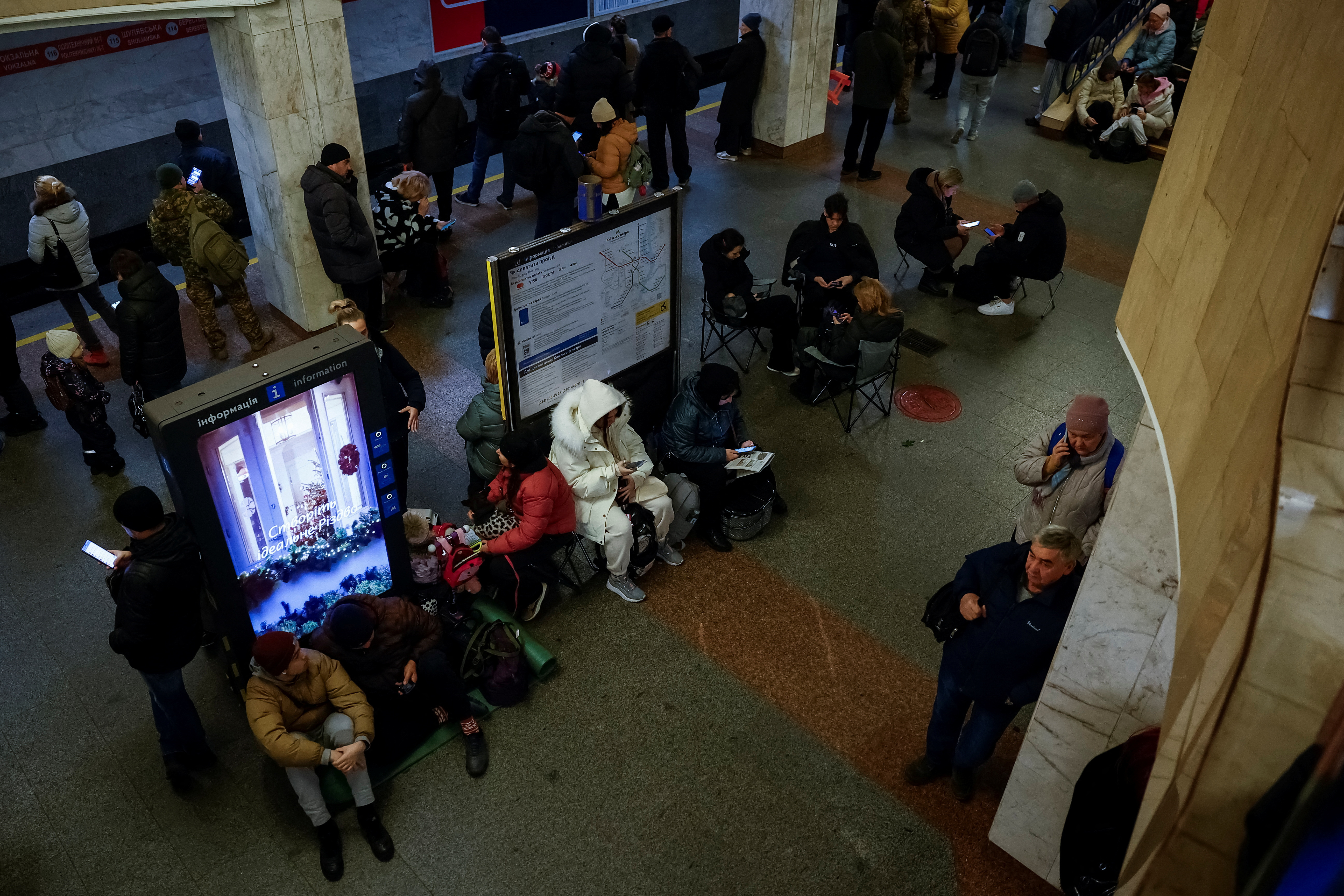 People take shelter inside a metro station during a Russian military attack, in Kyiv