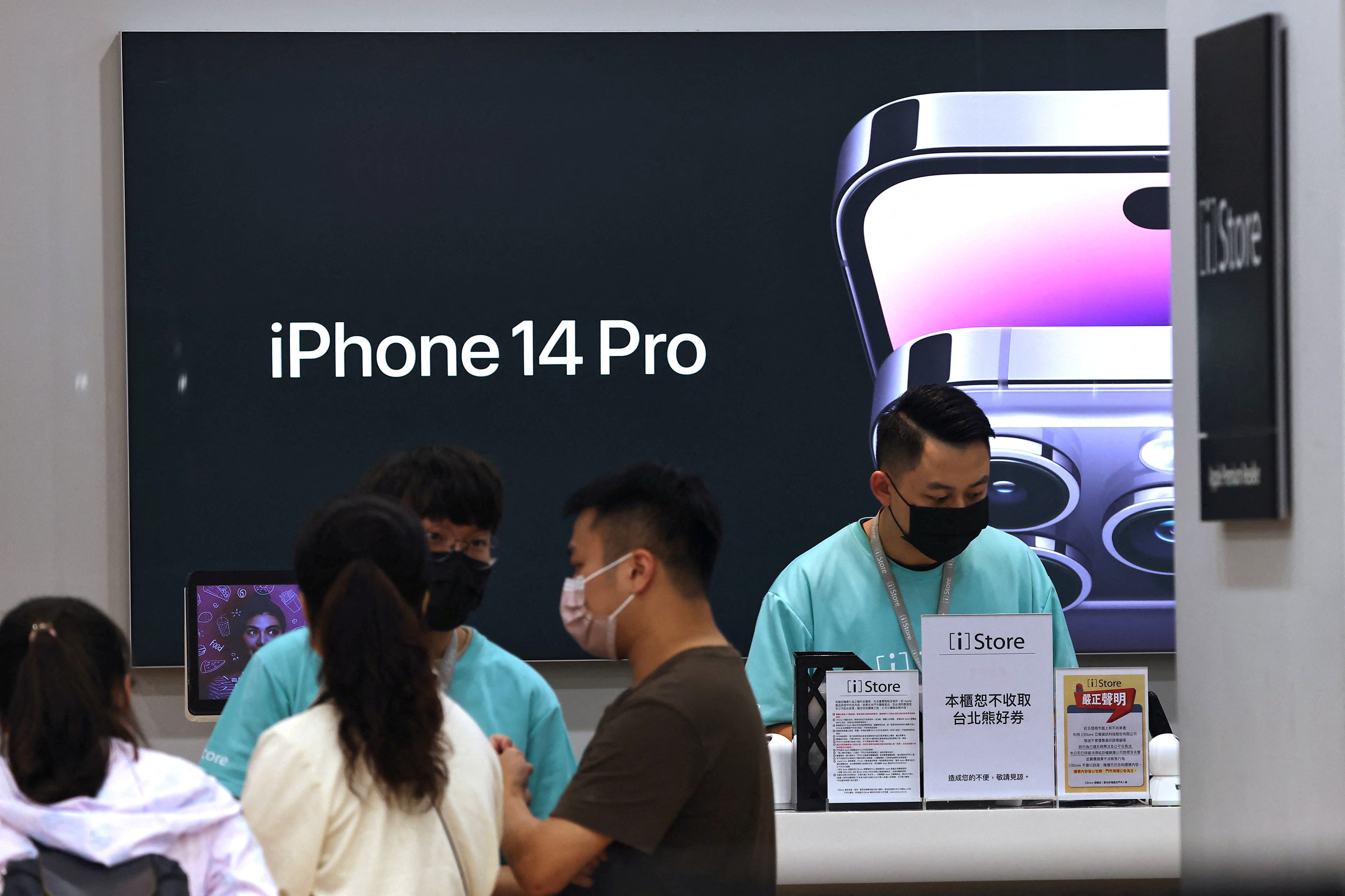 Customers visit an Apple store in Taipei, Taiwan, November 7, 2022.
