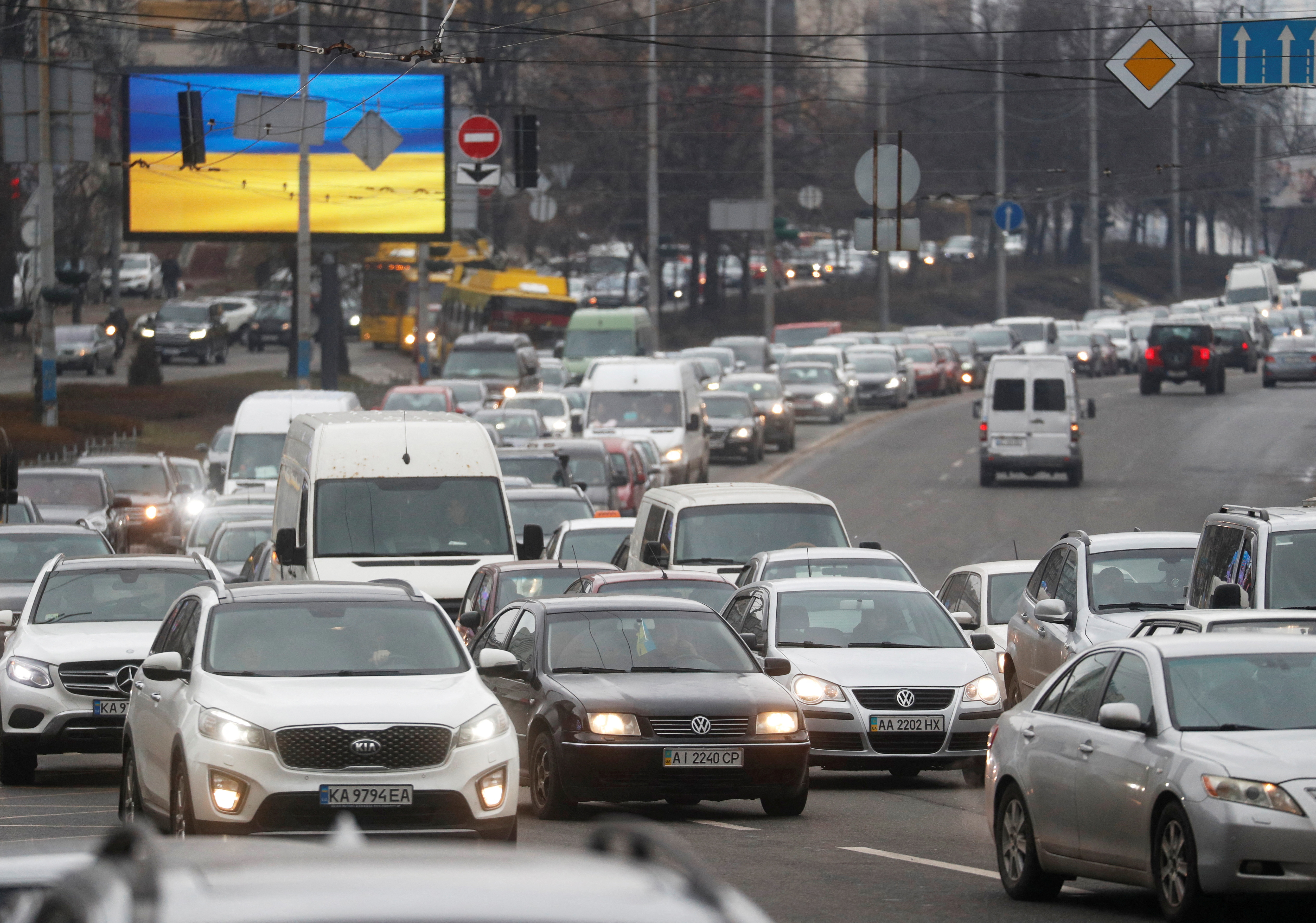 Cars drive towards the exit of the city after Russian President Vladimir Putin authorized a military operation in eastern Ukraine, in Kyiv
