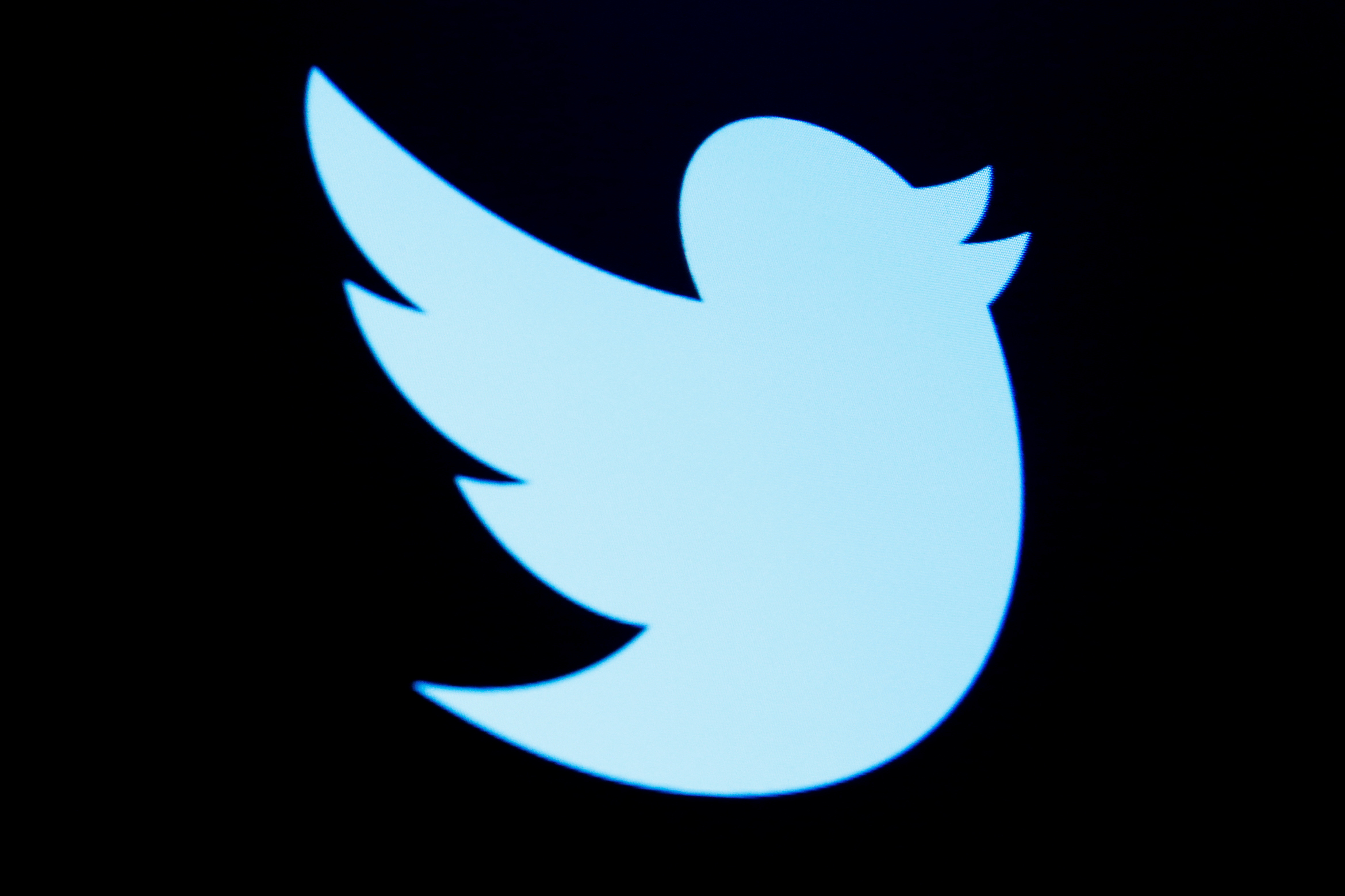 The Twitter logo is displayed on a screen on the floor of the NYSE