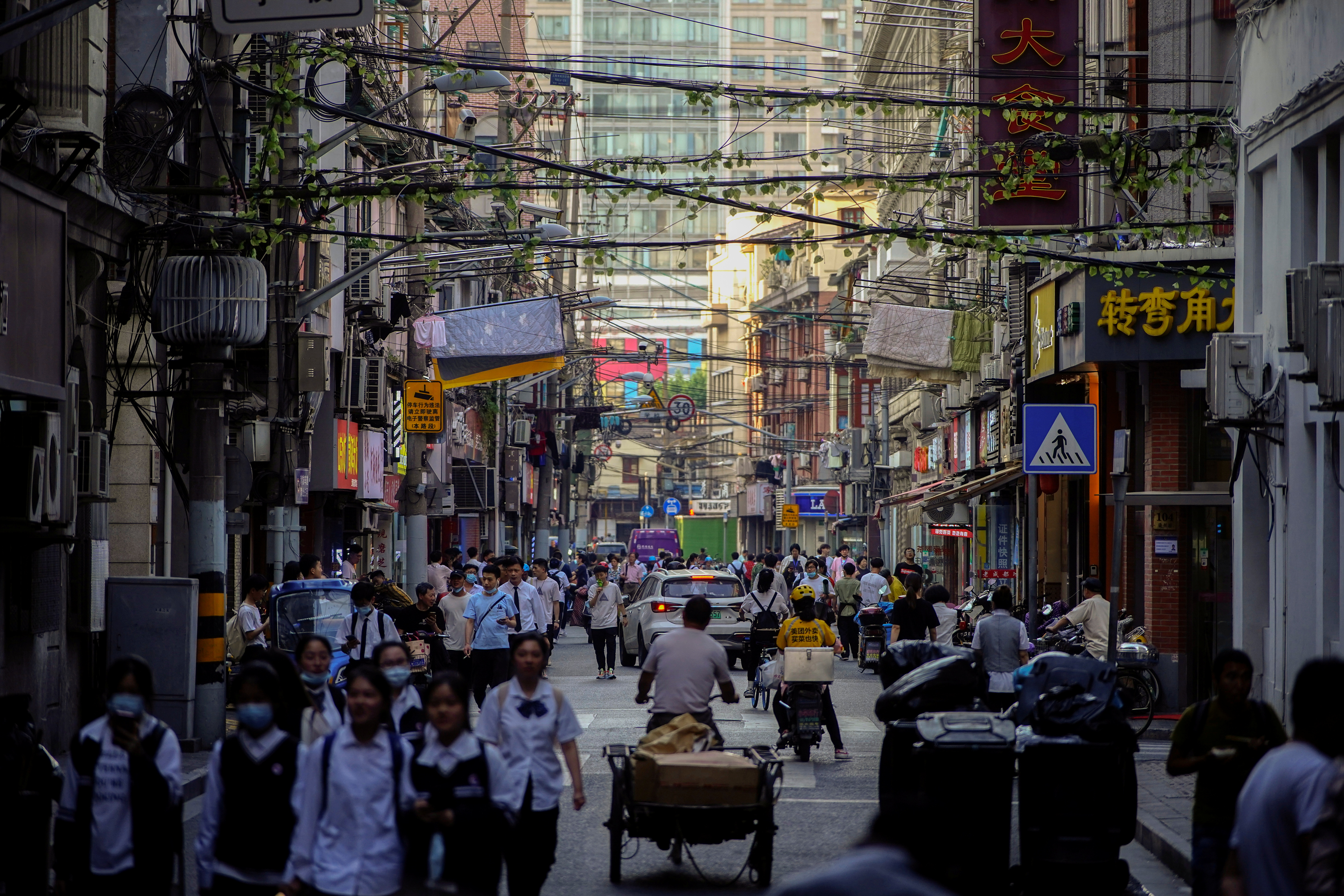 People walk along at a street, following the outbreak of the coronavirus disease (COVID-19), in Shanghai