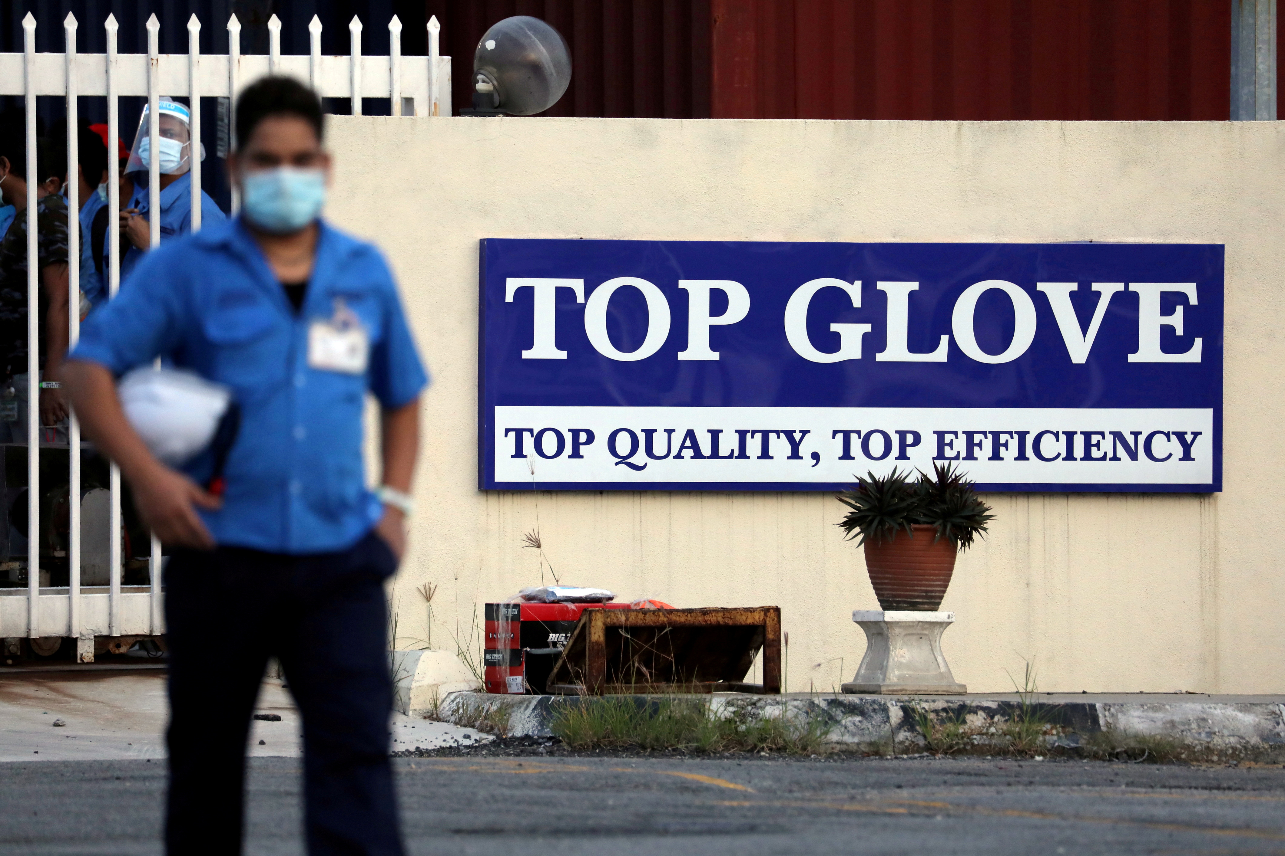 A worker leaves a Top Glove factory after his shift in Klang, Malaysia