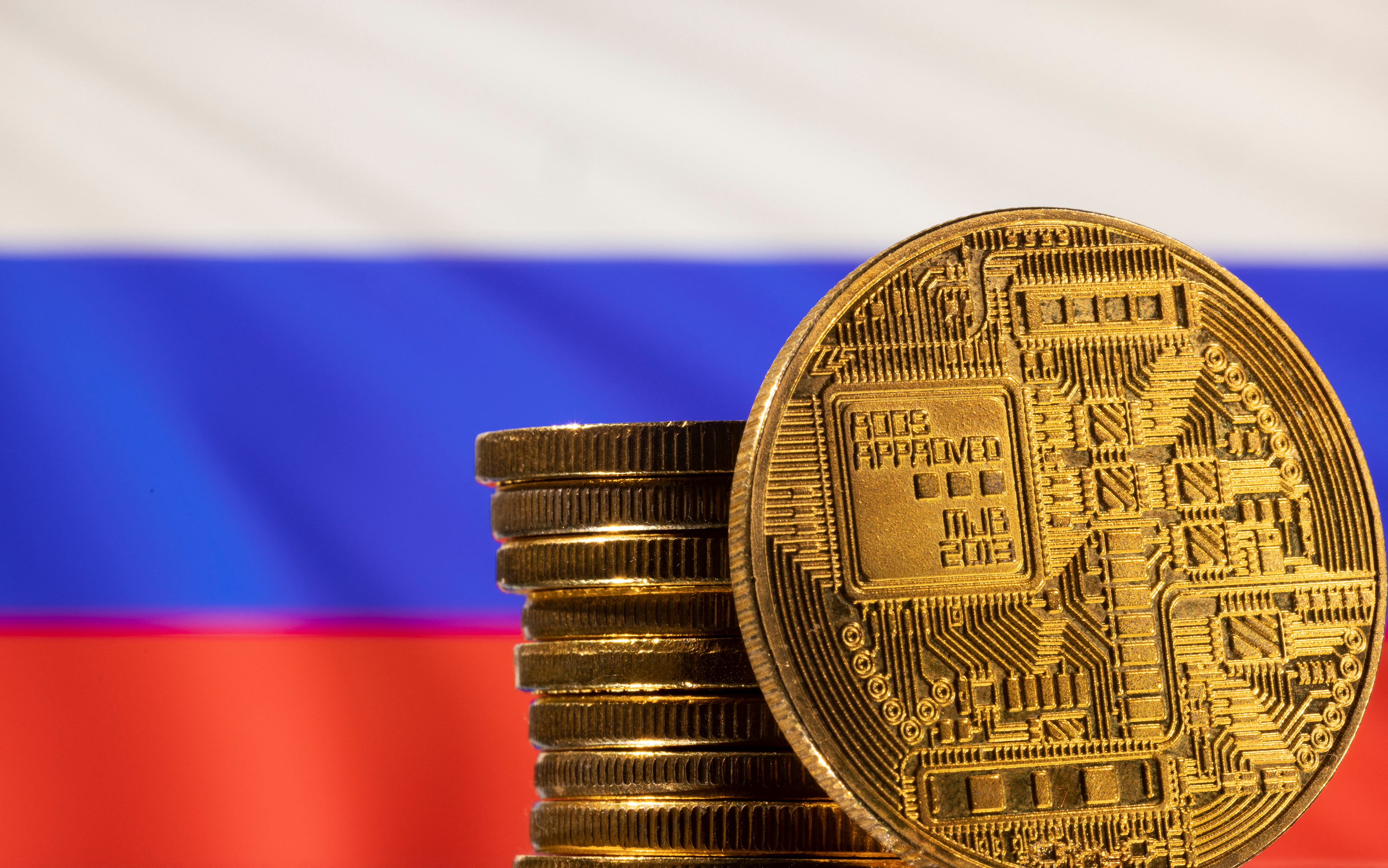 Illustration shows a representation of the cryptocurrency and Russian flag