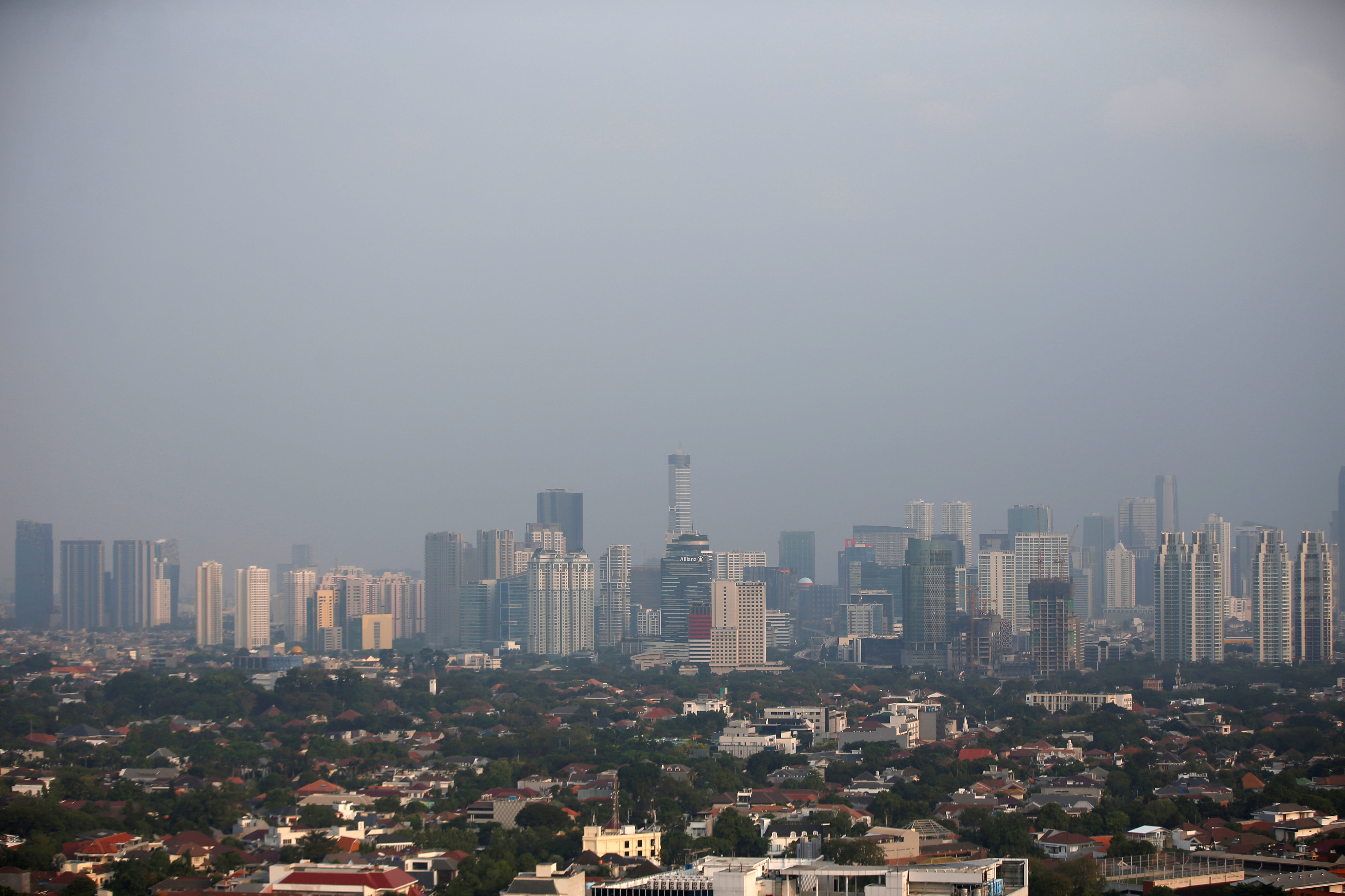 A general view of business buildings as smog covers the capital city of Jakarta