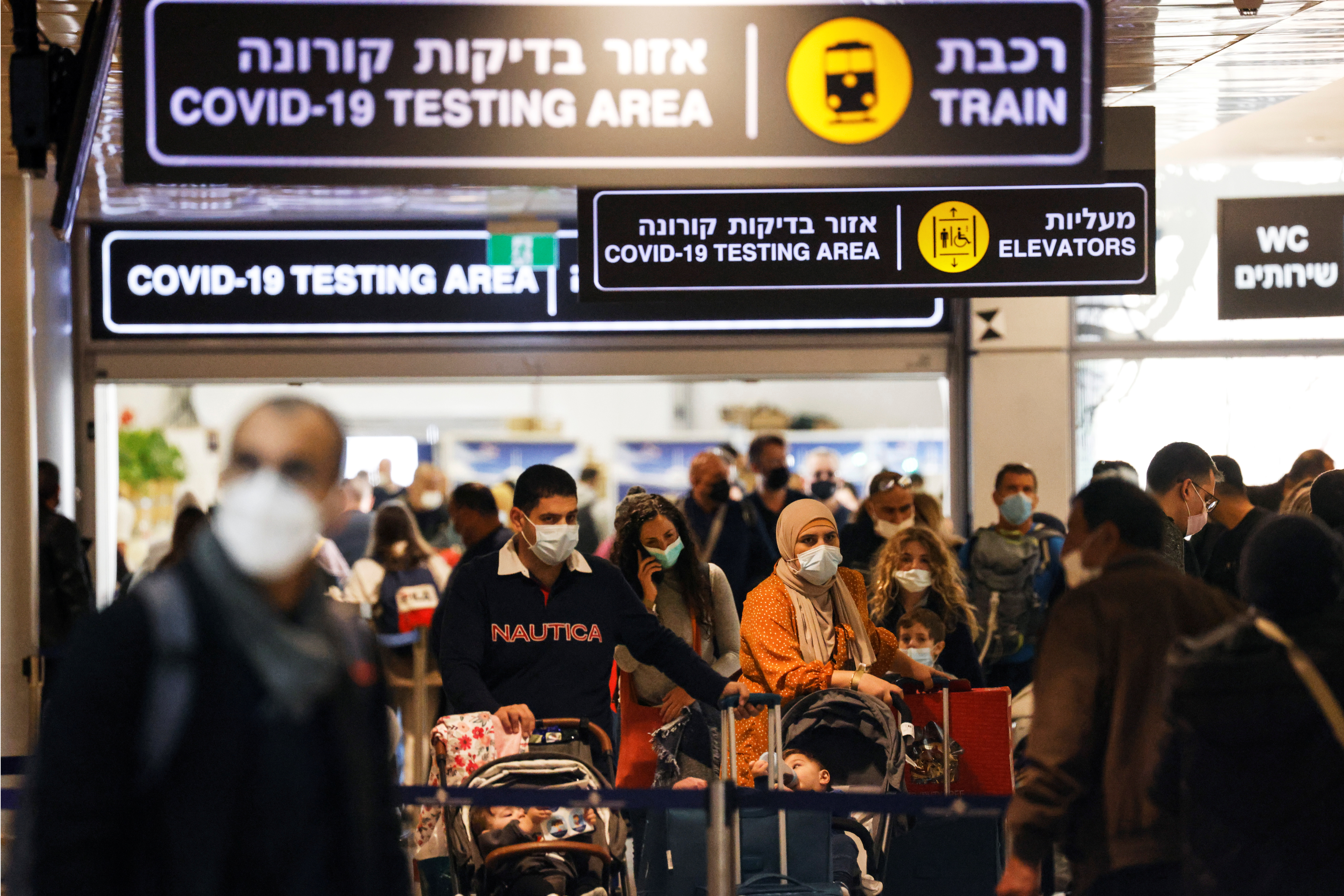 Travellers exit the coronavirus disease (COVID-19) pandemic testing area at Ben Gurion International Airport as Israel imposes new restrictions