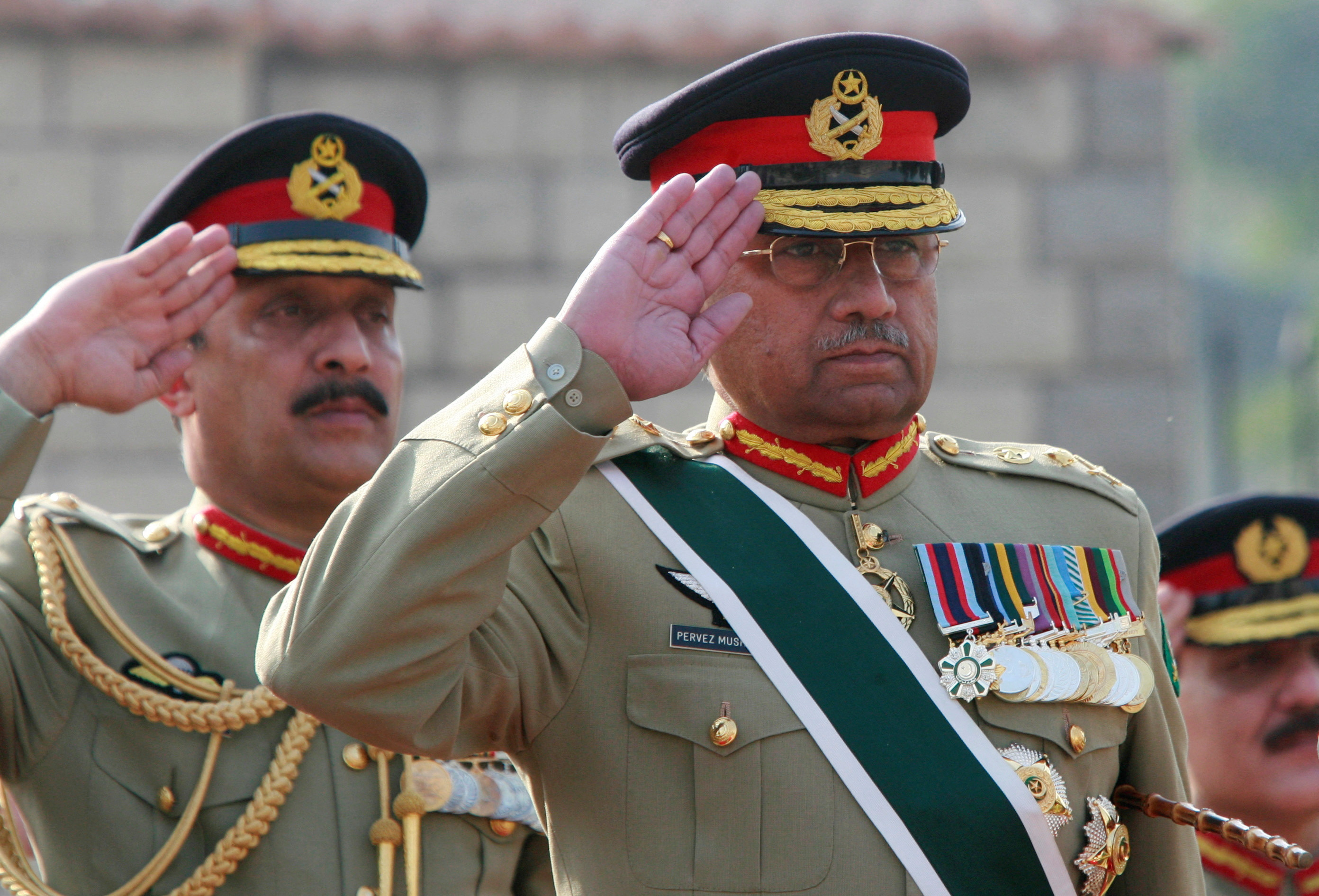 Pakistan's General Pervez Musharraf salutes during the playing of Pakistan's national anthem at the Joint Staff headquarters in Rawalpindi
