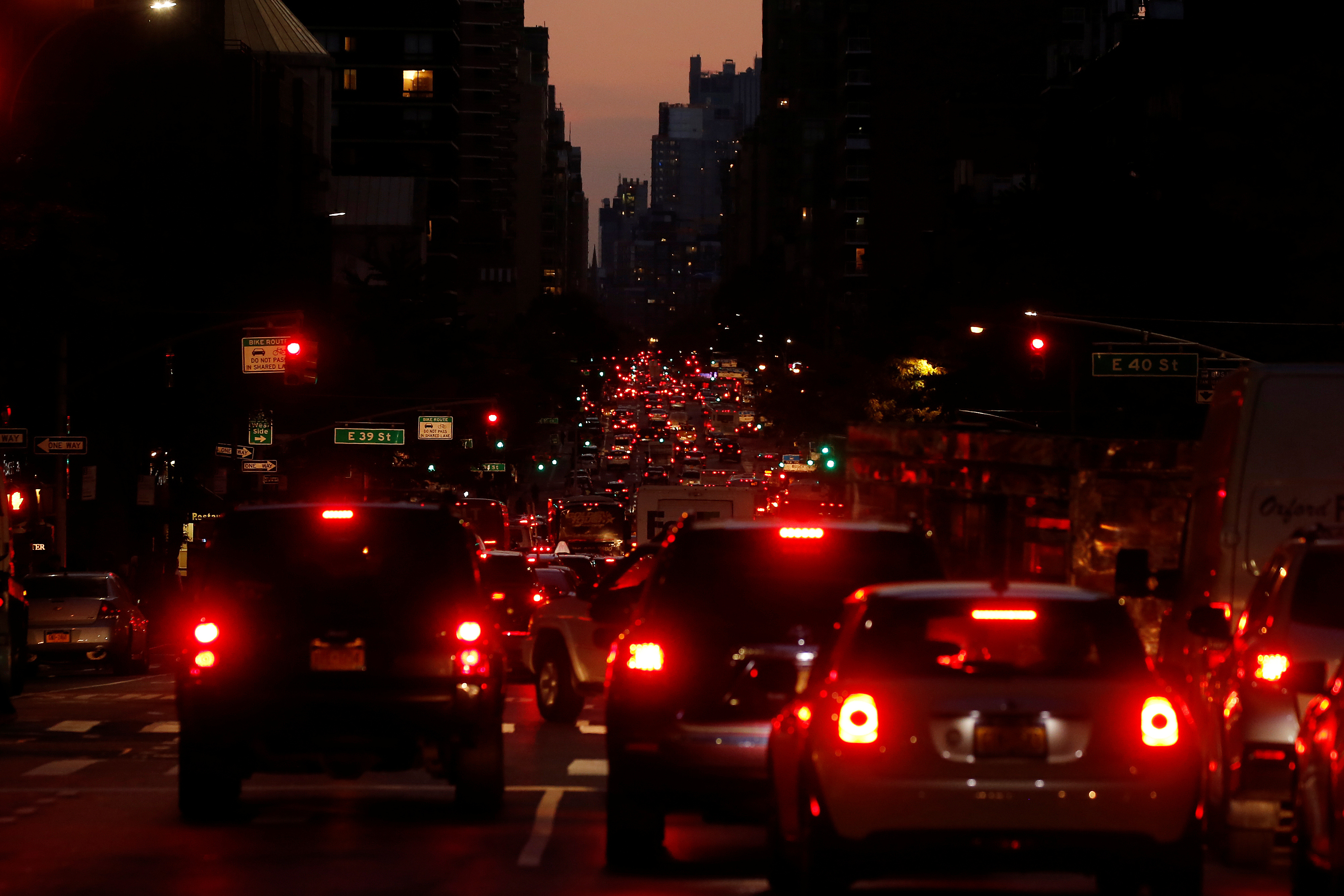 Red tail lights light up 2nd Ave as cars and trucks head downtown at sunset in the Manhattan borough of New York