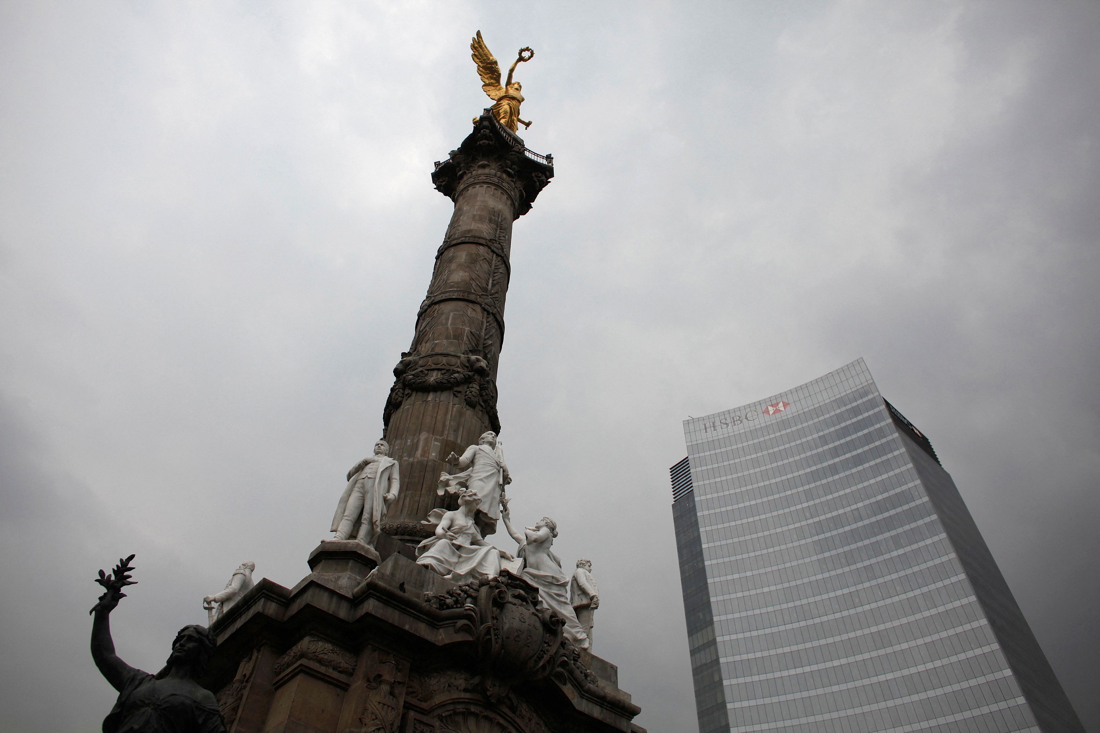 The Angel of Independence monument stands next to British bank HSBC's headquarters in Mexico City