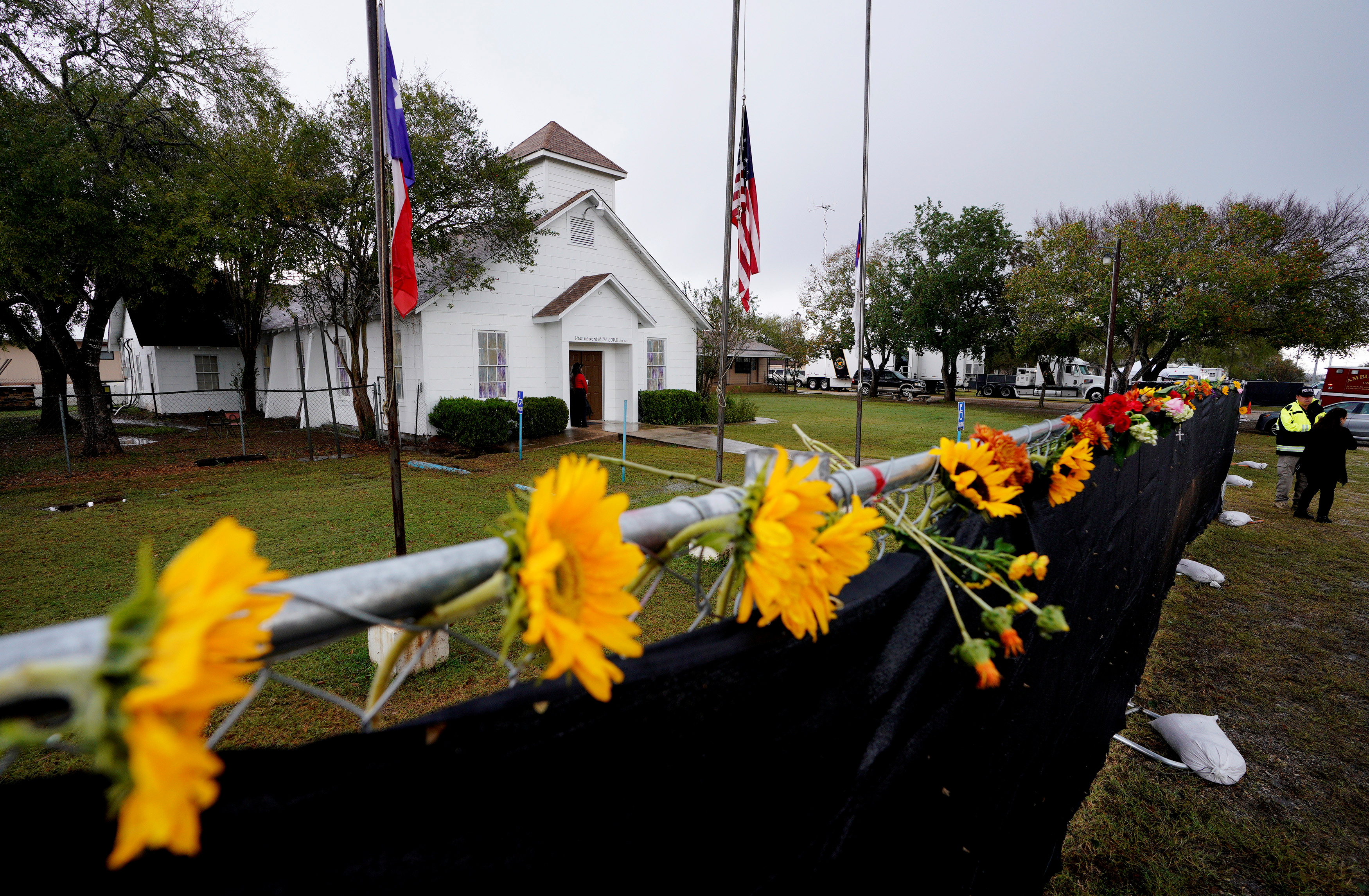 Flowers decorate the fence around the First Baptist Church of Sutherland Springs where 26 people were killed one week ago, as the church opens to the public as a memorial to those killed