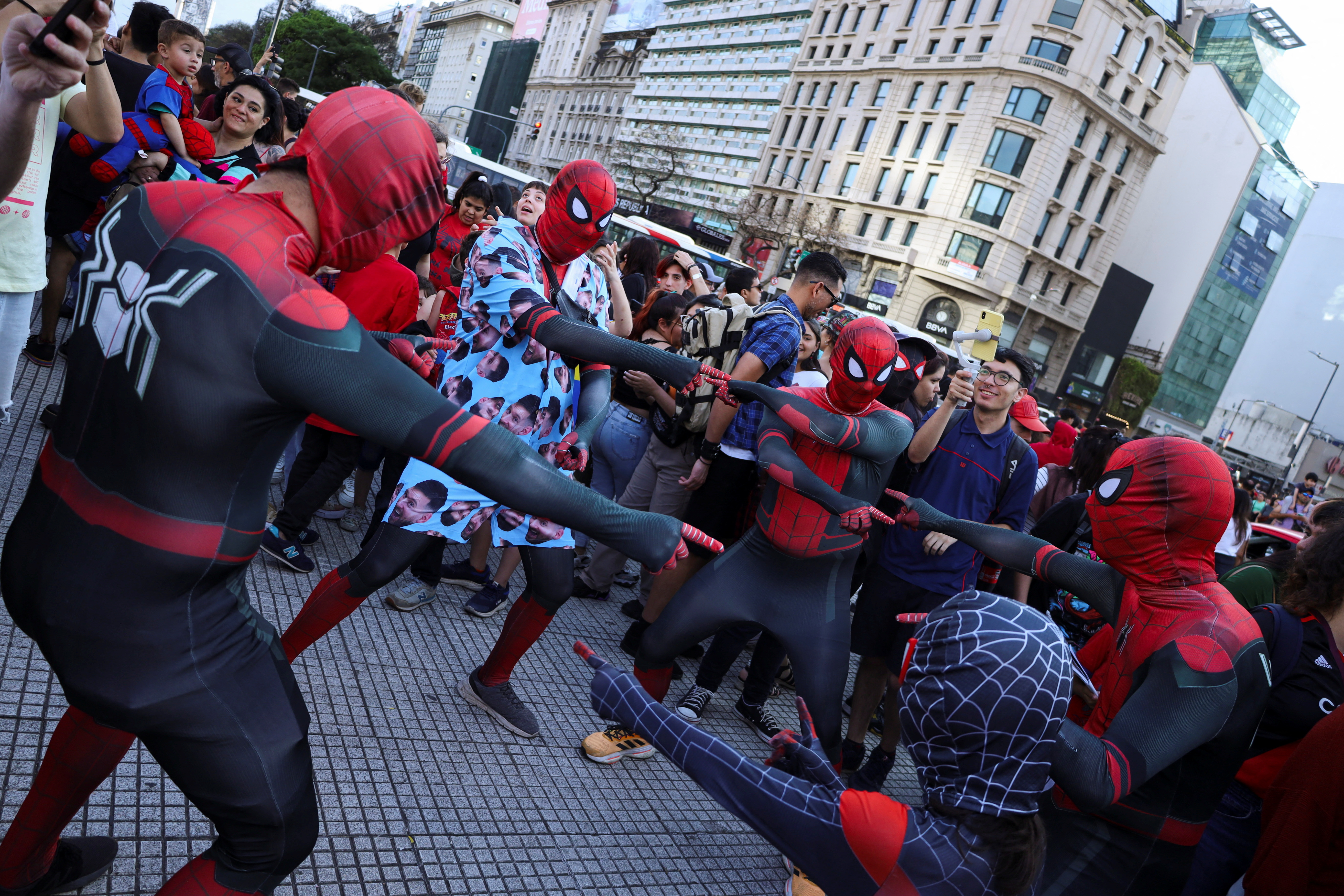 4 spiderman cosplayers on the street