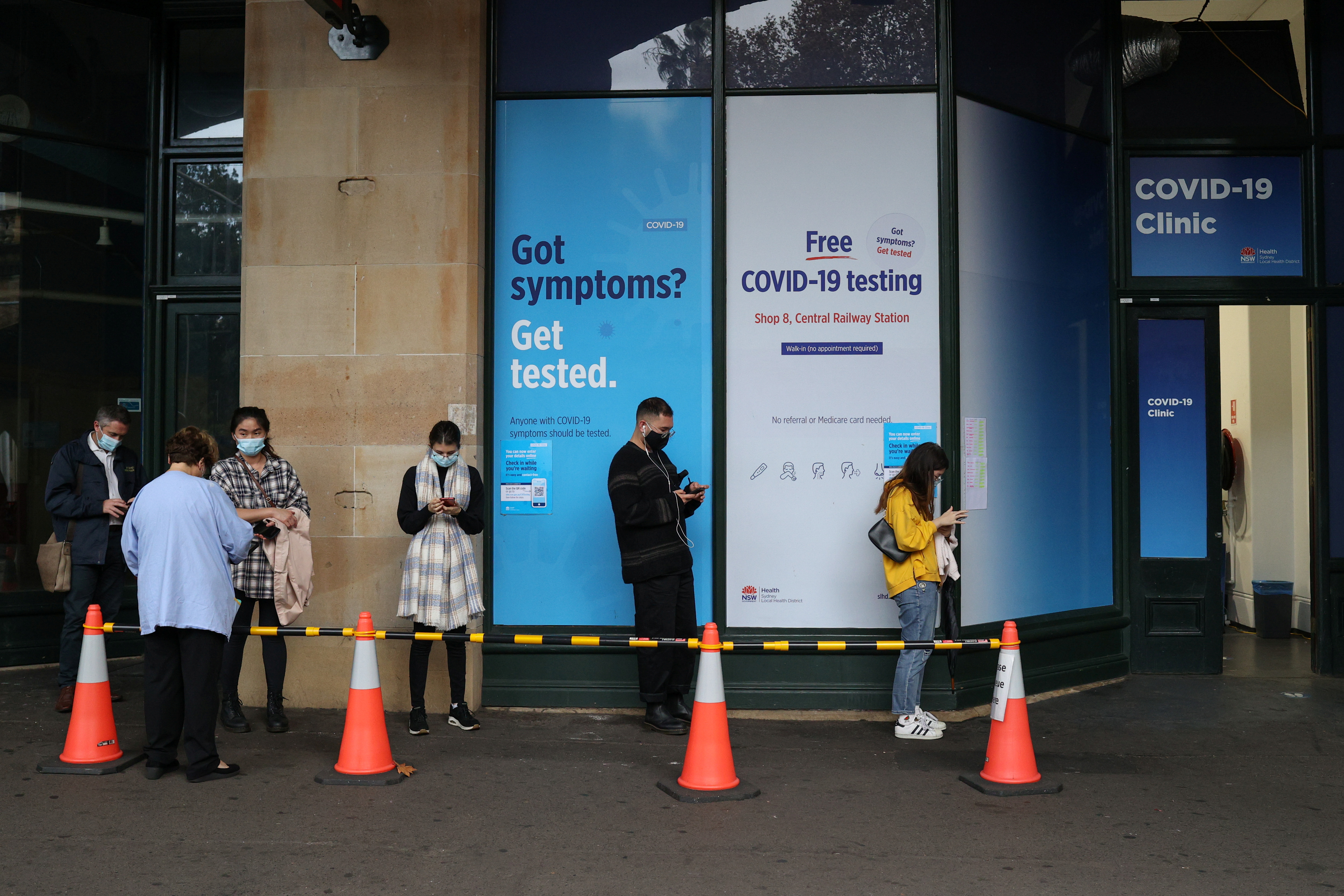People wait in line at a coronavirus disease (COVID-19) testing clinic in Sydney