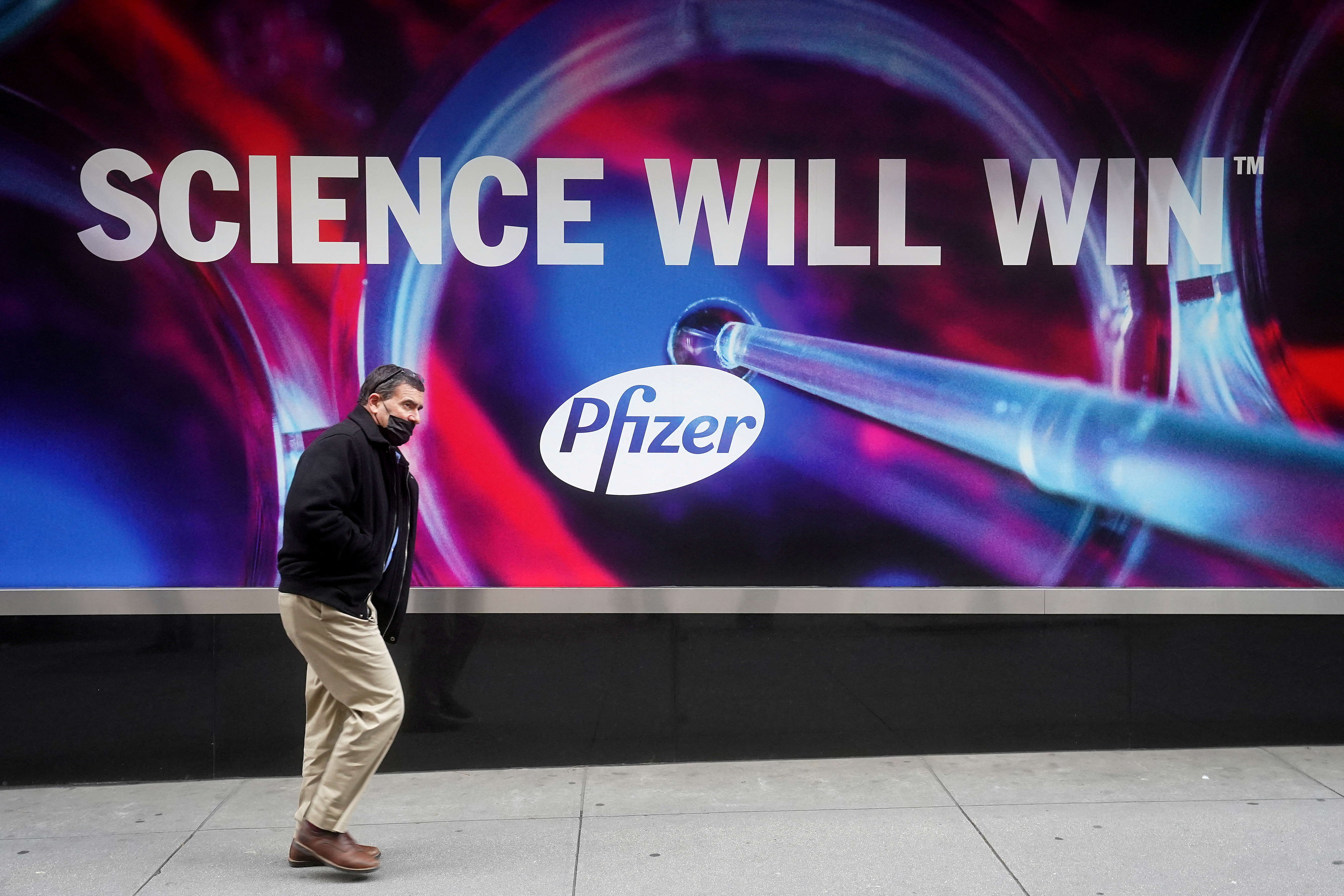 A person walks past the Pfizer Headquarters building in New York City