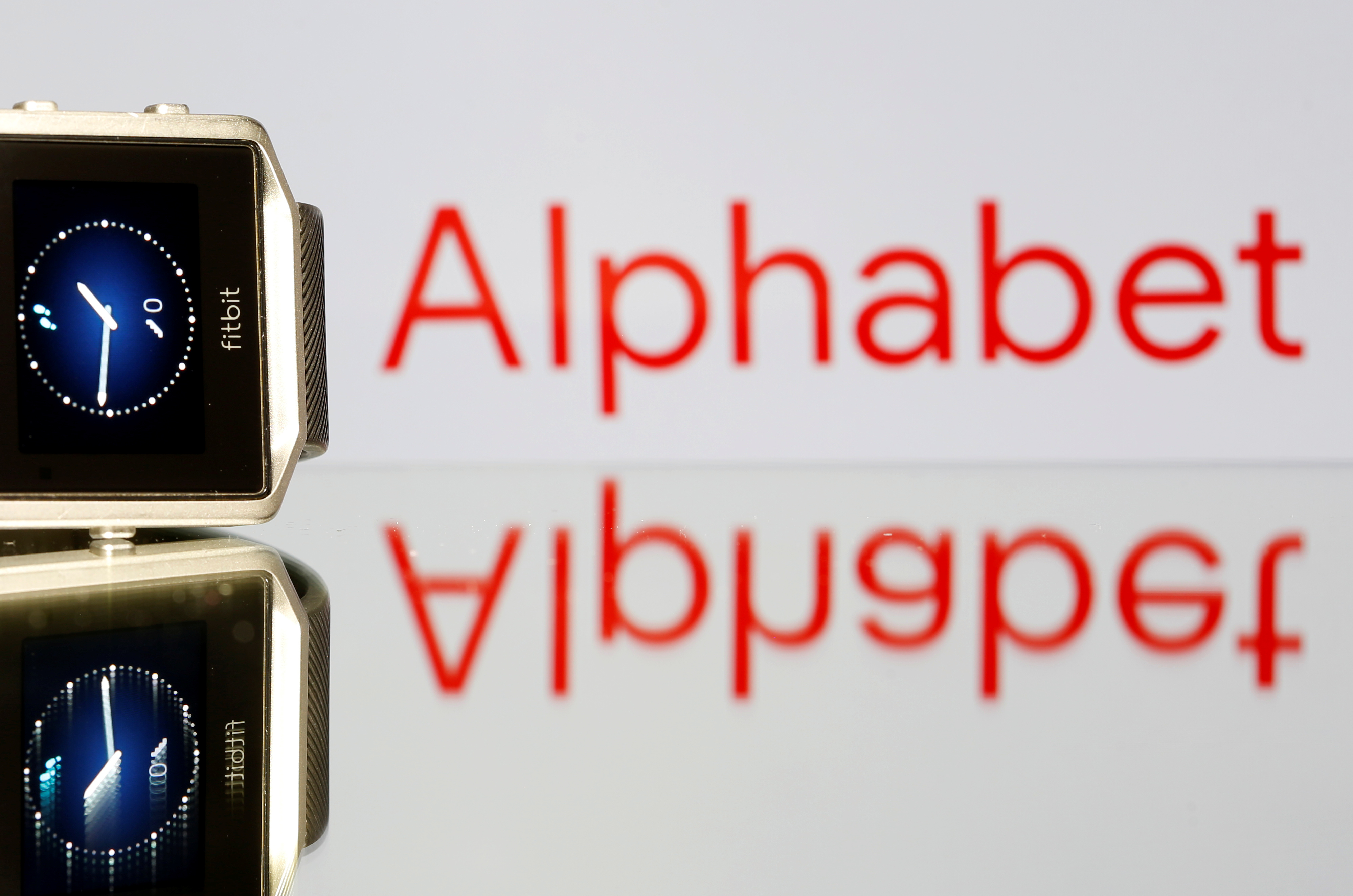 Fitbit Blaze watch is seen in front of a displayed Alphabet logo in this illustration