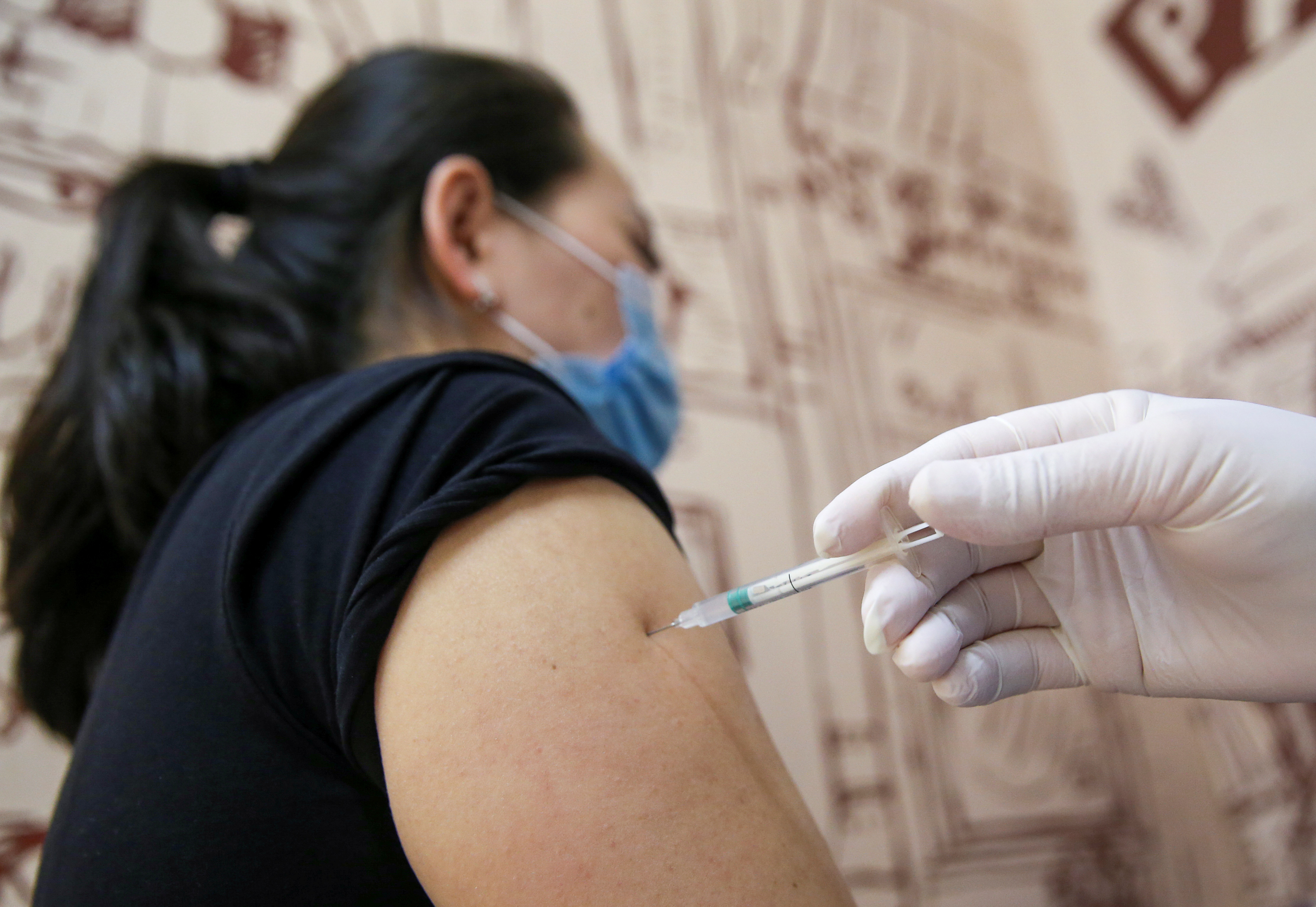 A woman receives a dose of the QazCovid-in vaccine in Almaty