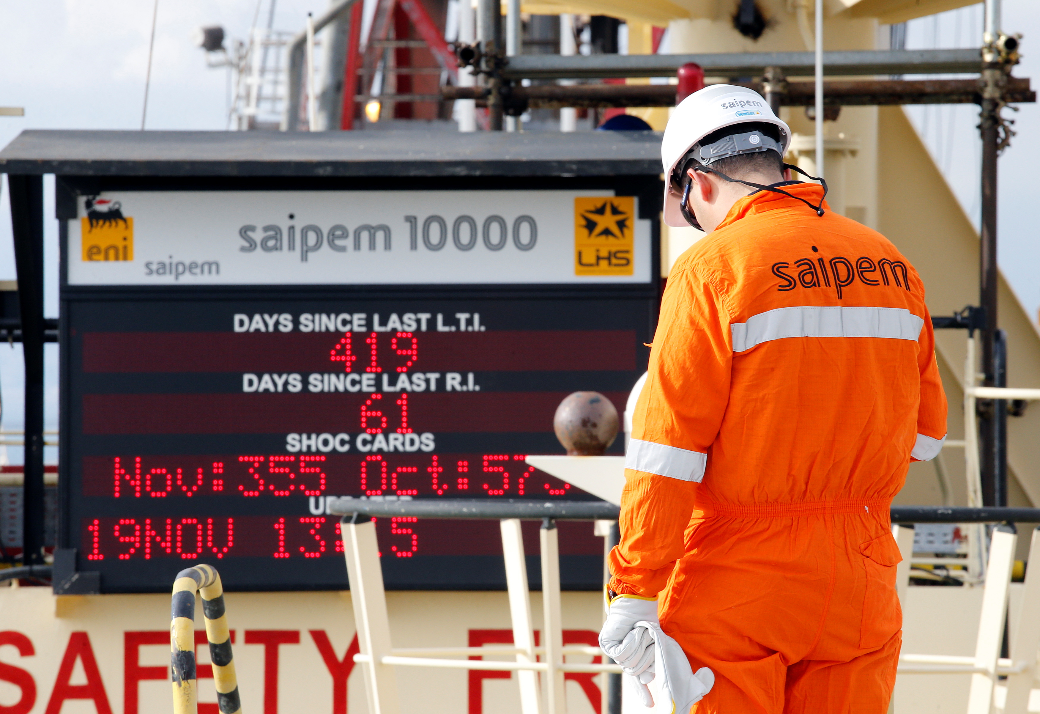 A staff member is seen on the Saipem 10000 deepwater drillship in Genoa's harbour