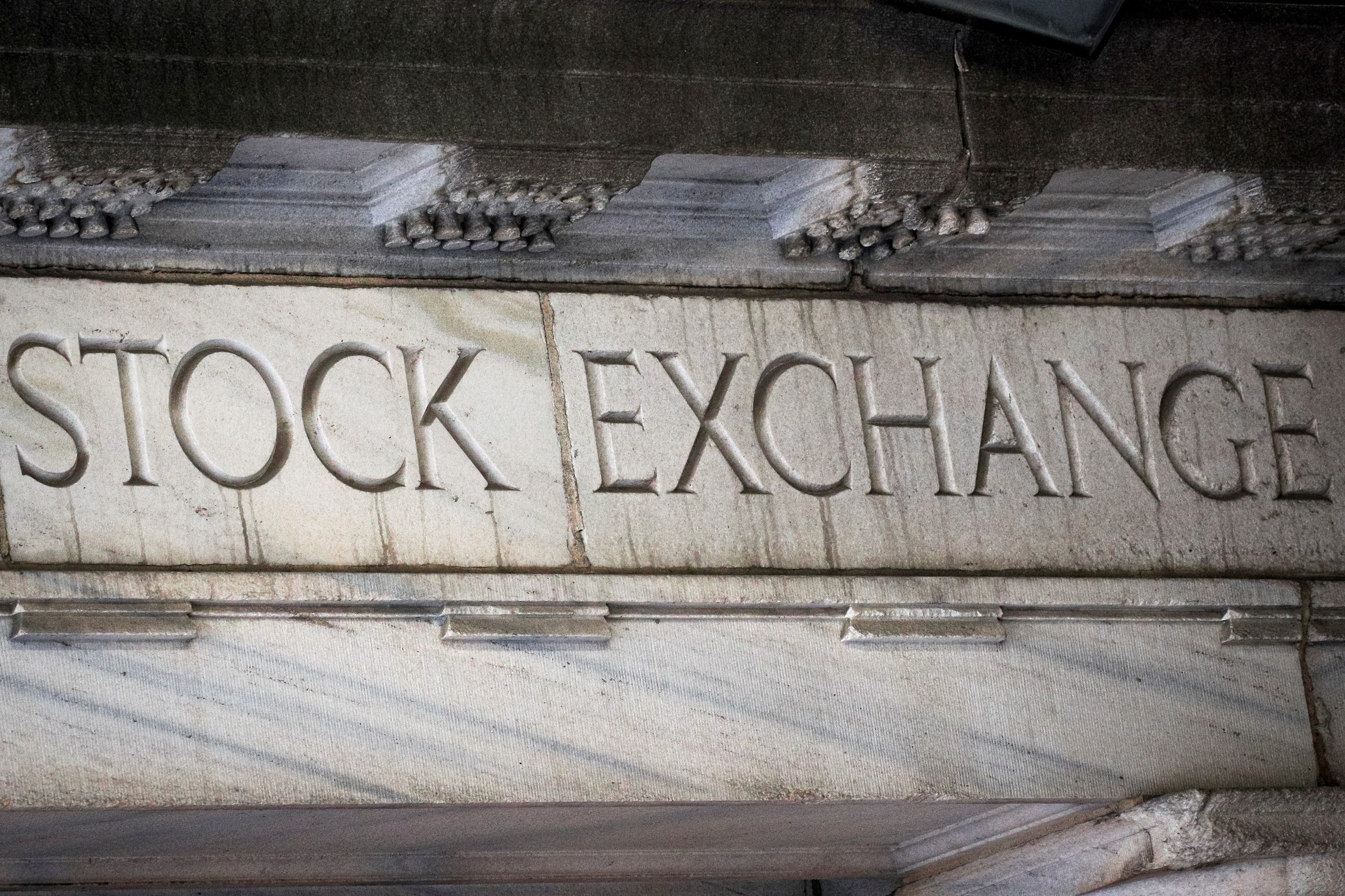 Stock Exchange is seen over an entrance to the NYSE on Wall St. in New York