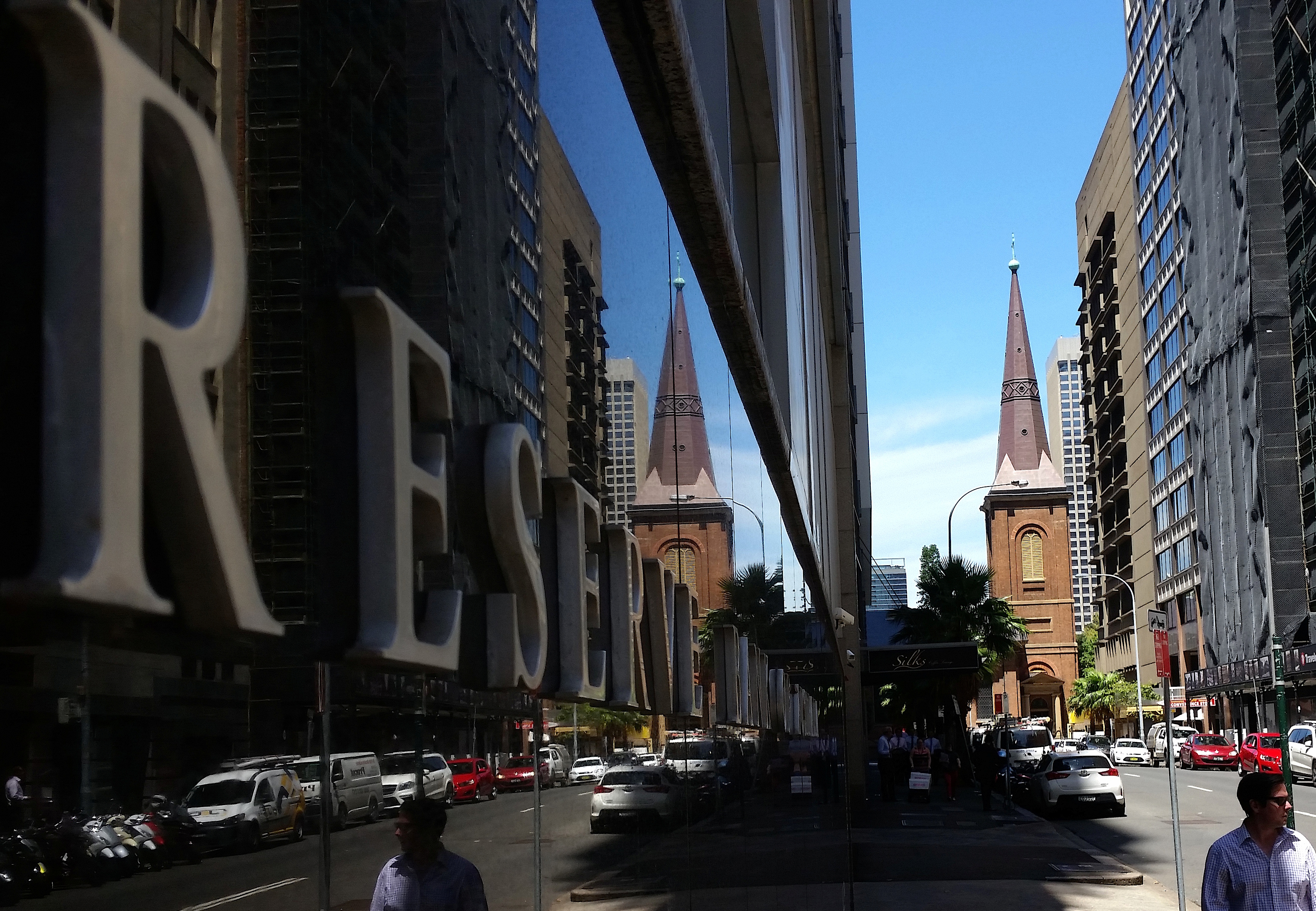 Pedestrians walk past the Reserve Bank of Australia building in central Sydney