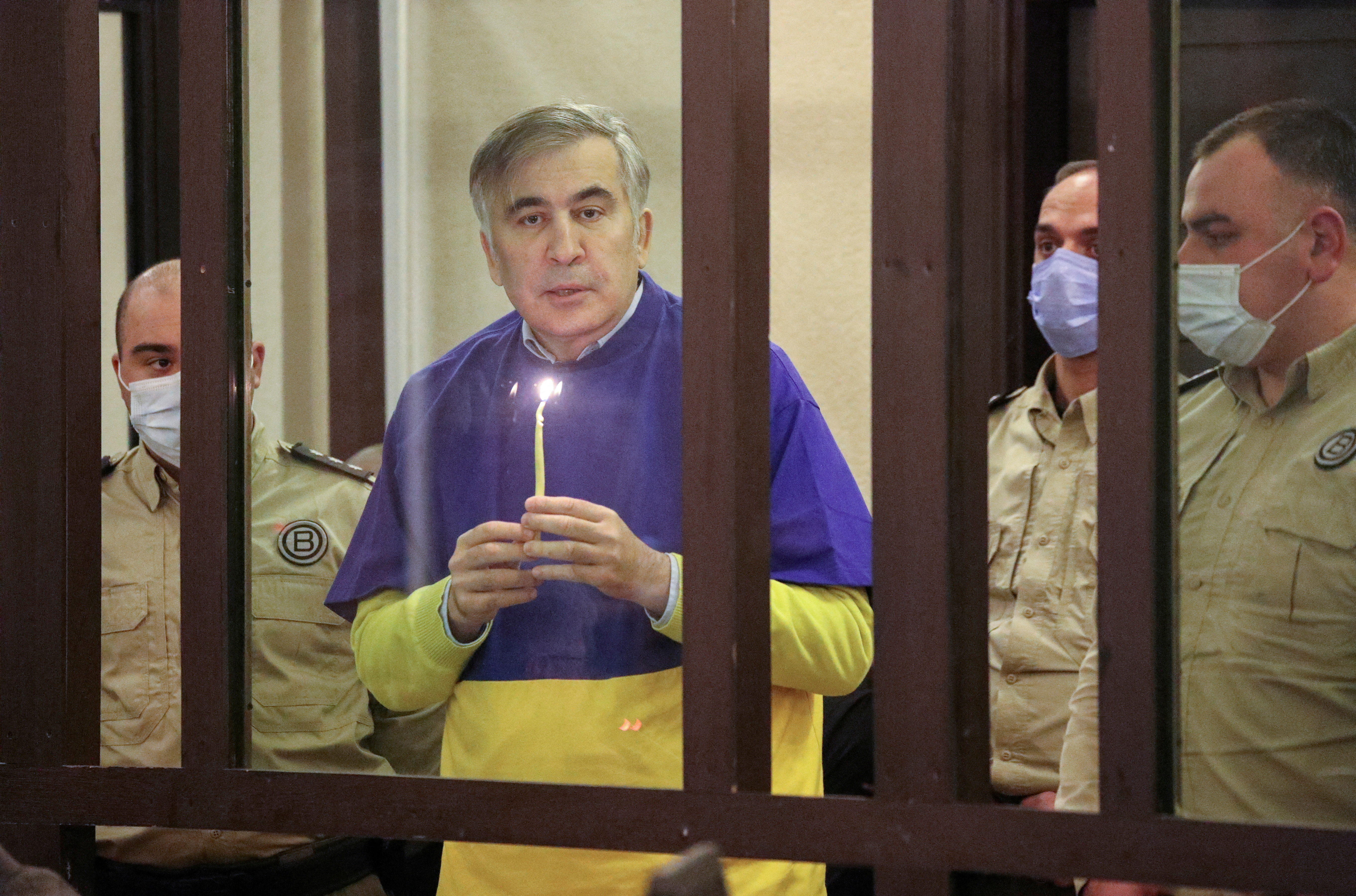 Georgian former President Saakashvili prays for Ukraine during a court hearing in Tbilisi