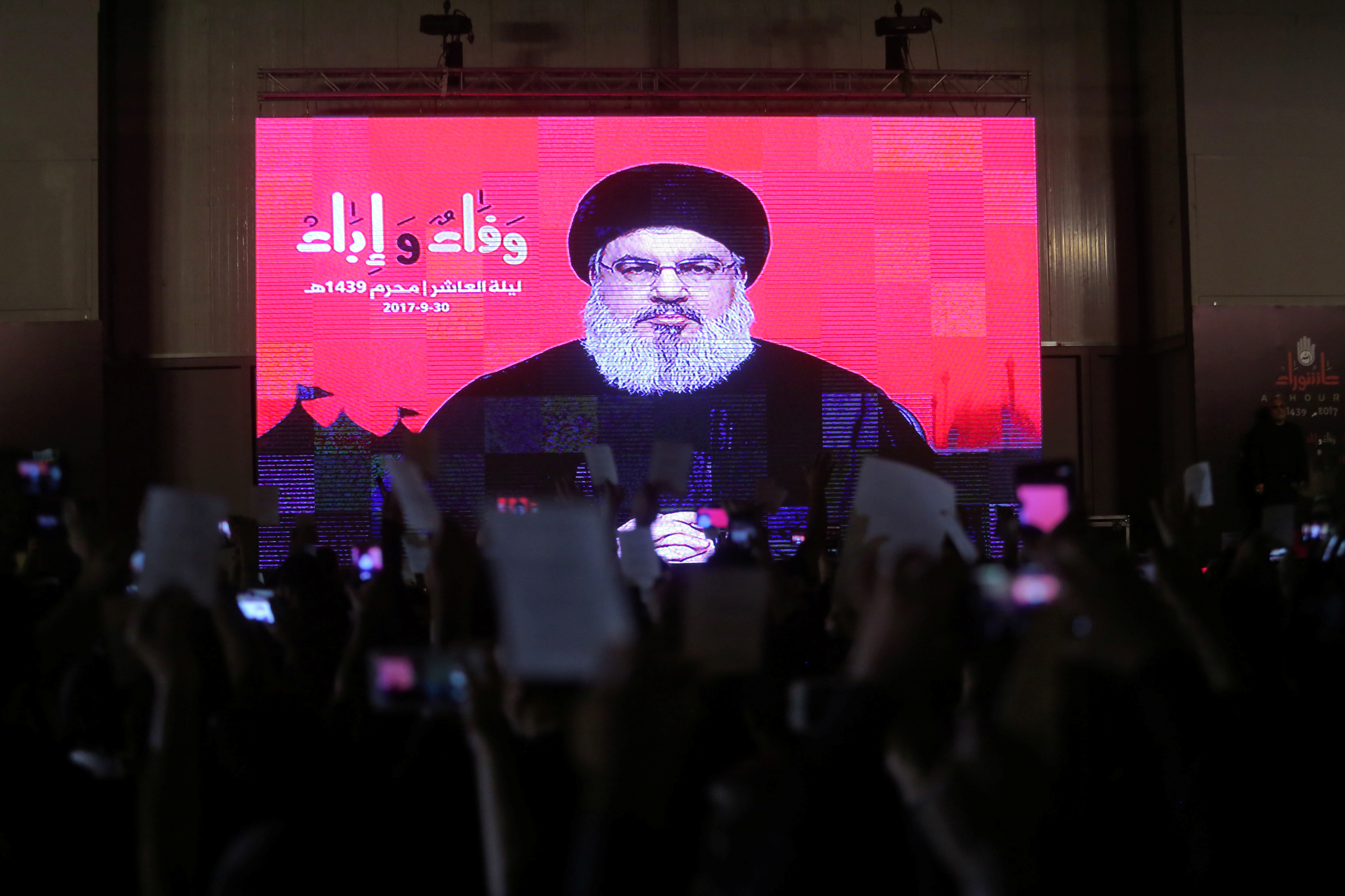 Lebanon's Hezbollah leader Sayyed Hassan Nasrallah is seen on a video screen as he addresses his supporters during a ceremony of the latest day of Ashoura in Beirut