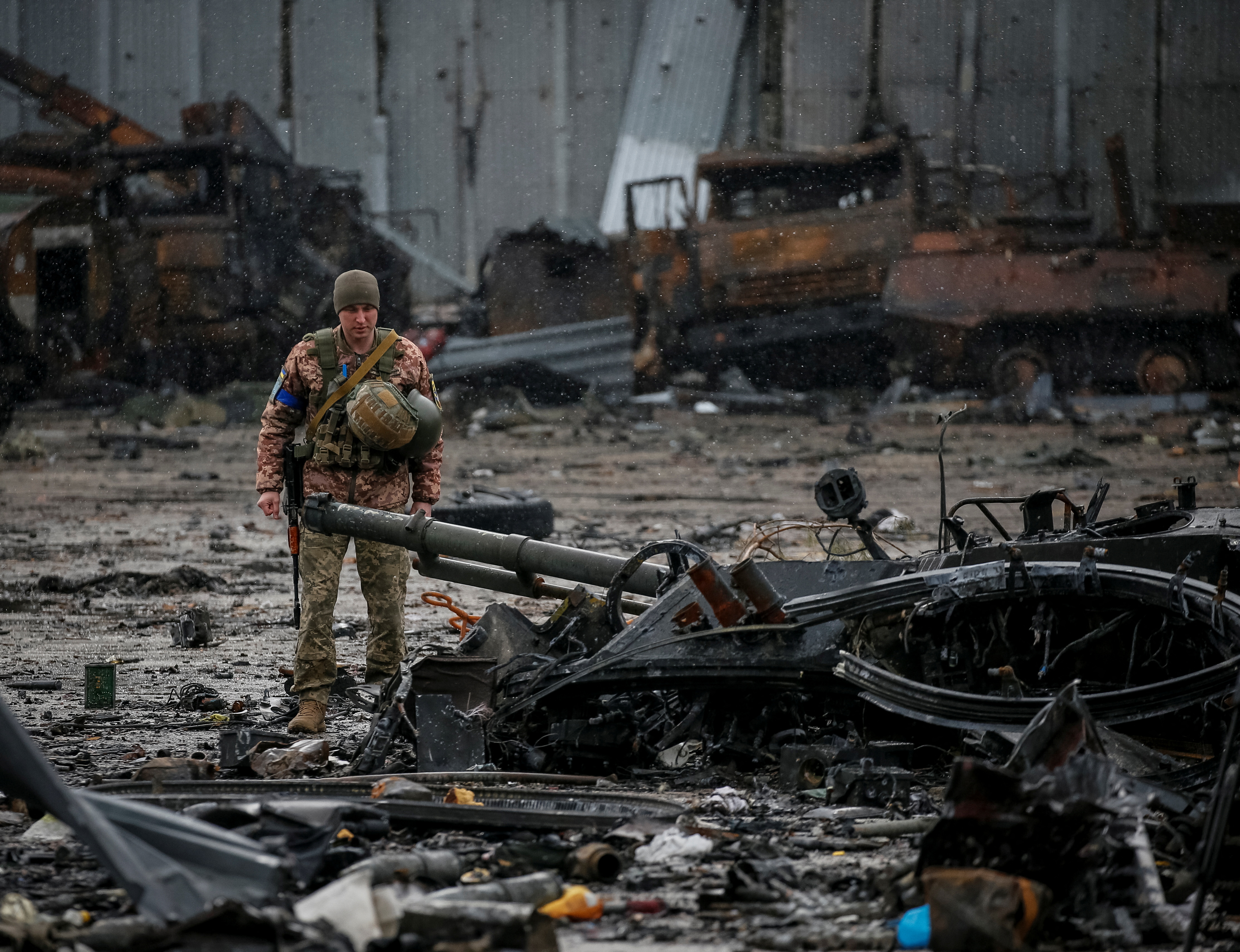 A Ukrainian service member inspects a compound of the Antonov airfield in the settlement of Hostomel