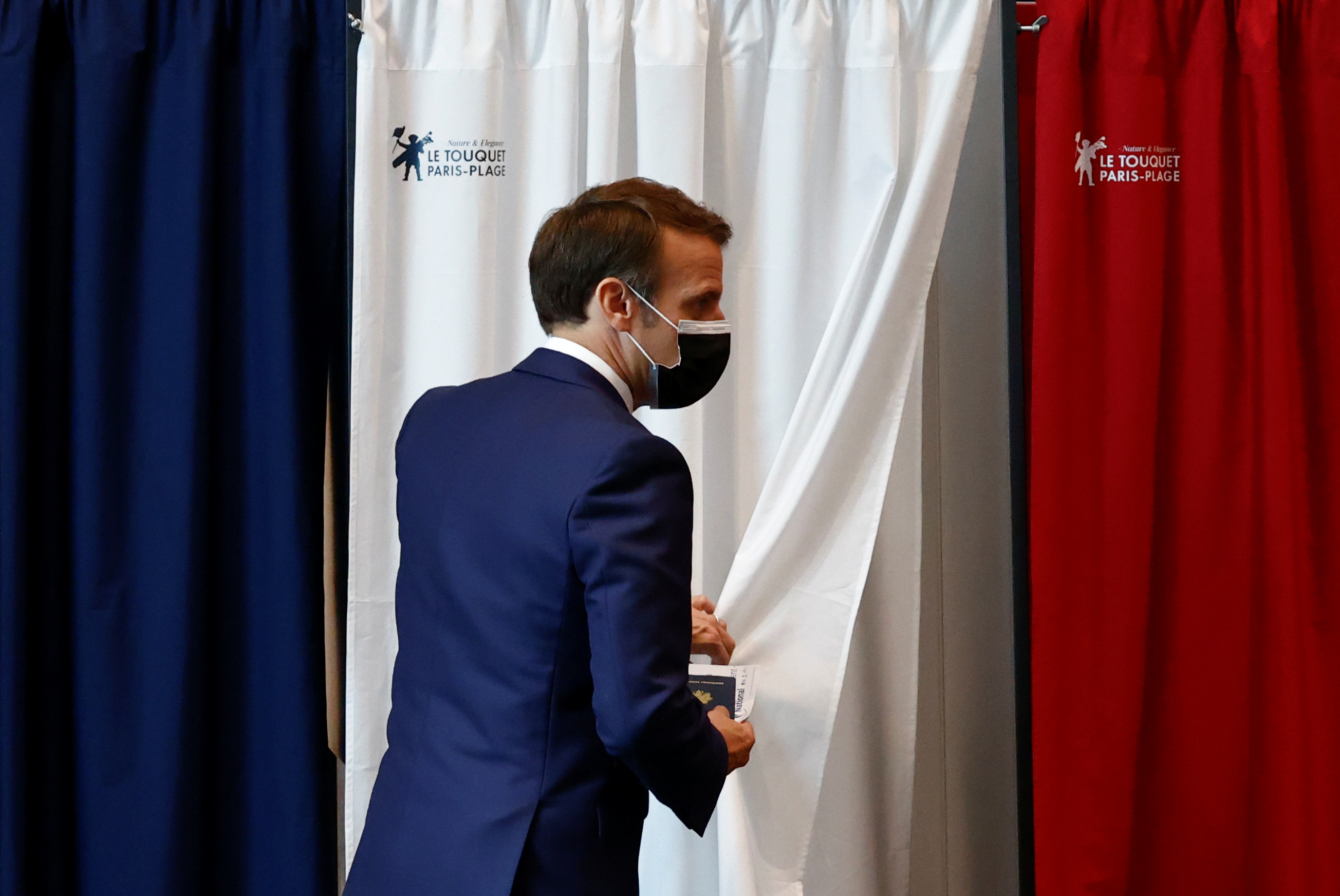 French President Emmanuel Macron is seen at a polling station during the first round of French regional and departmental elections, in Le Touquet-Paris-Plage, France, June 20, 2021. REUTERS/Christian Hartmann/Pool