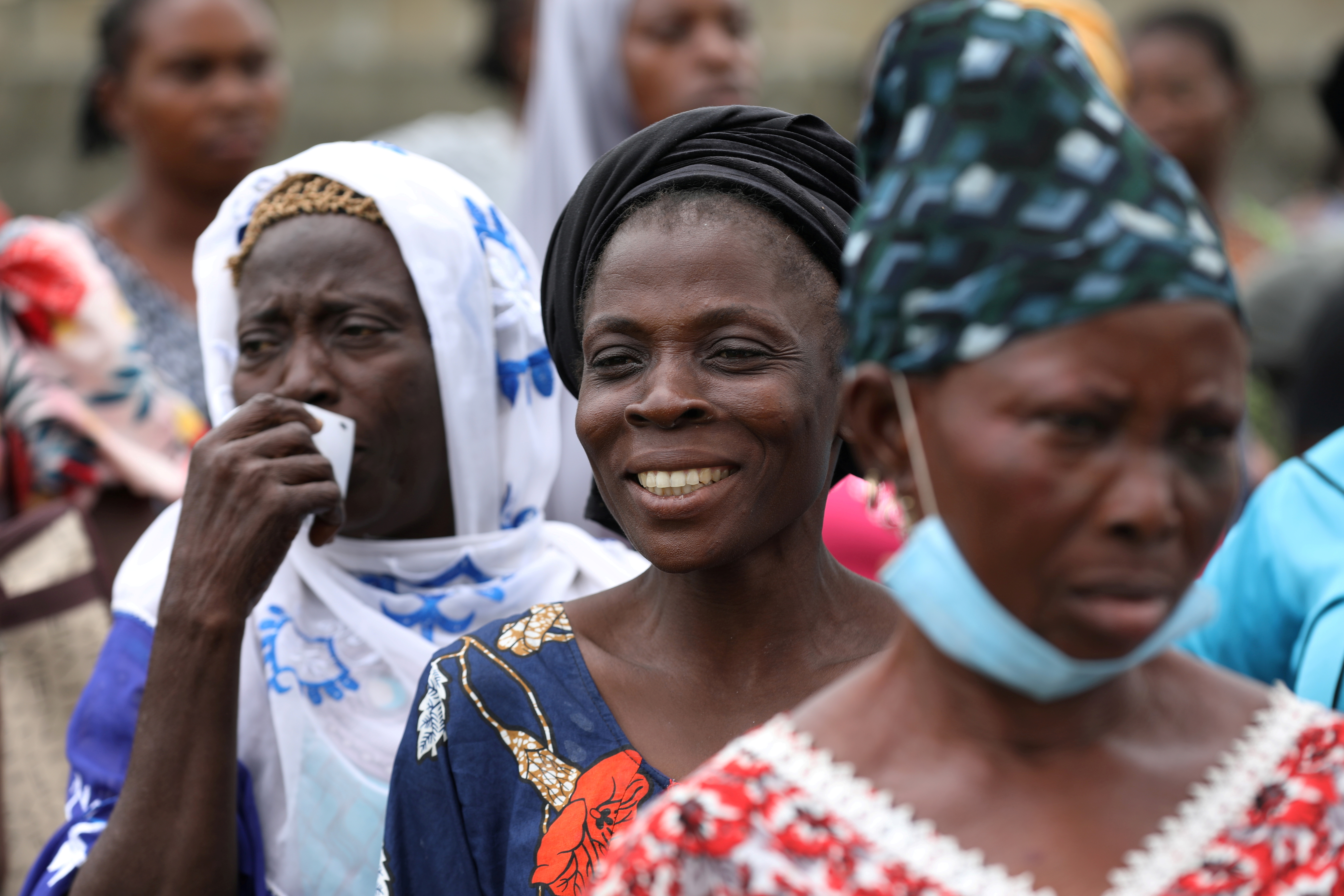 Women queue for food parcels during distribution by volunteers of the Lagos food bank initiative in a community in Oworoshoki, Lagos