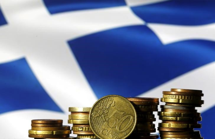 Euro coins are seen in front of a displayed Greece flag in this picture illustration