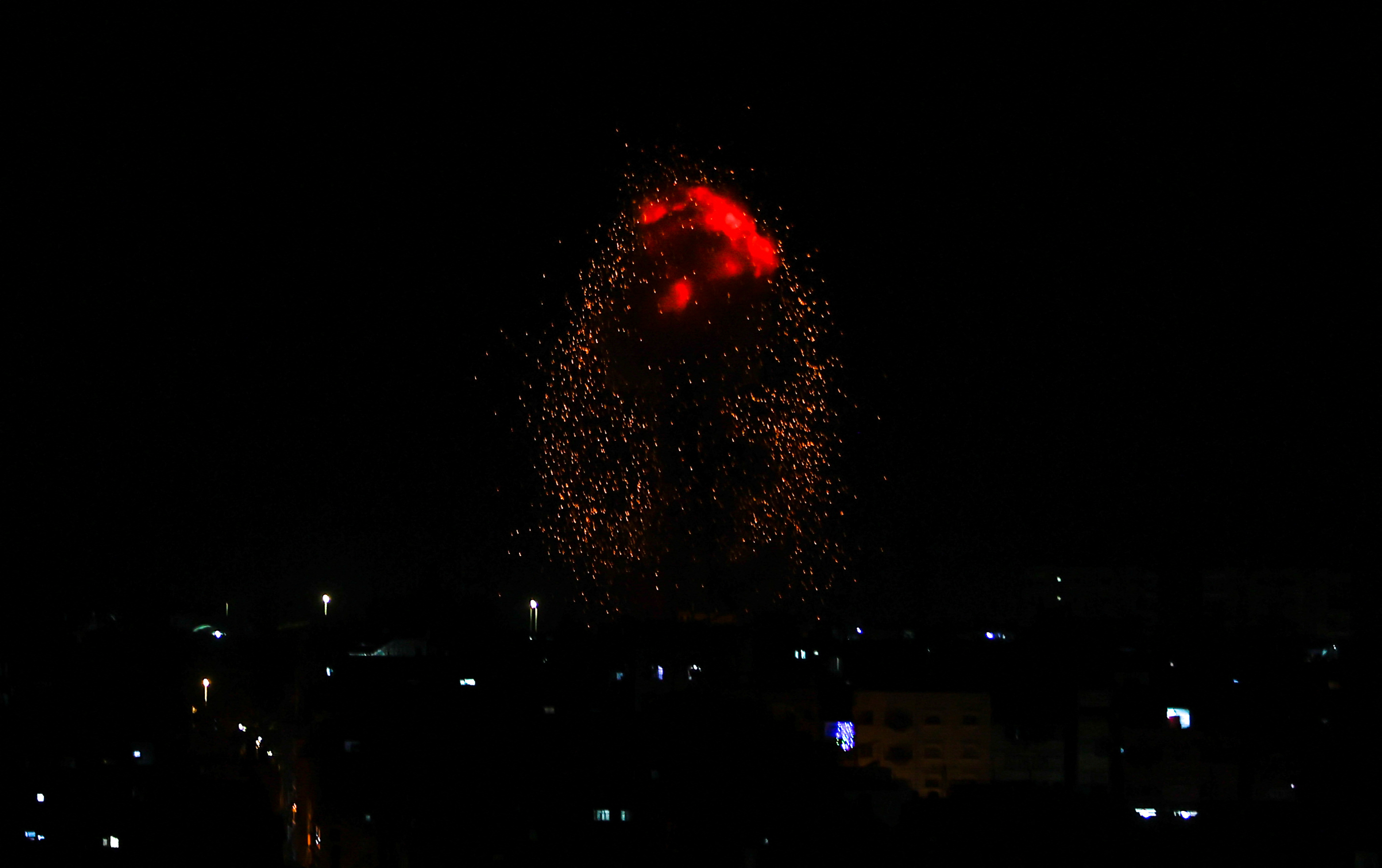 Flames rise, following an Israeli air strike in Gaza